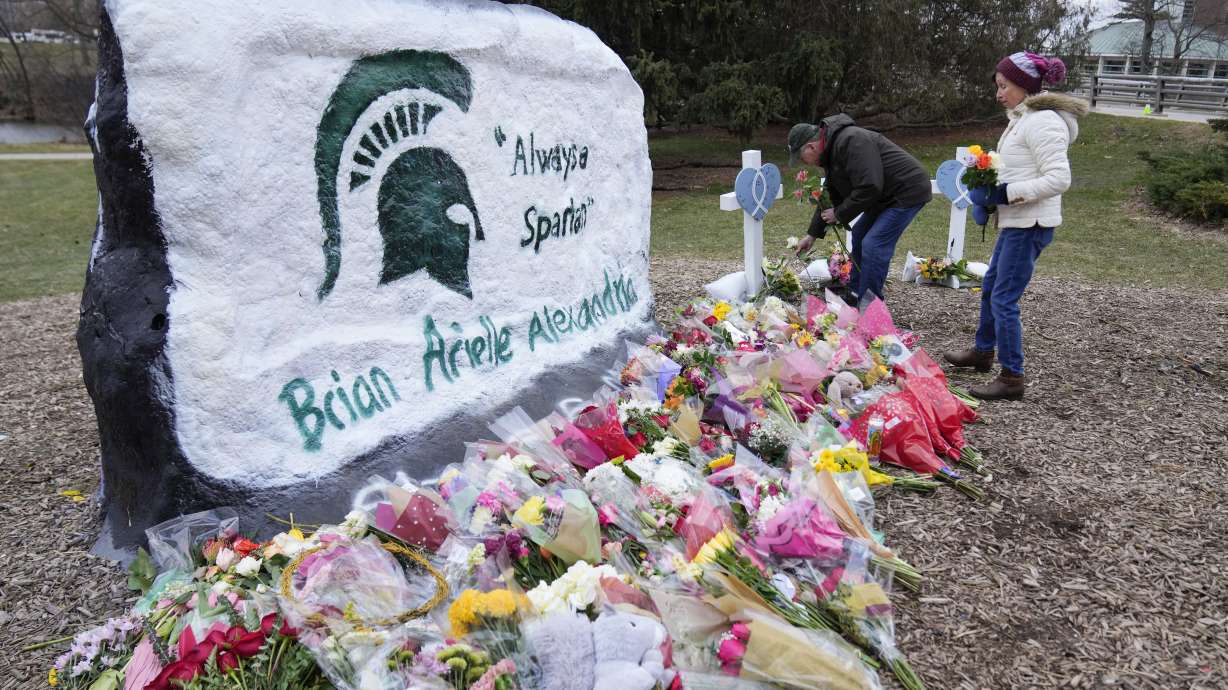 Mourners leave flowers at The Rock on the grounds of Michigan State University in East Lansing, Mich., on Feb. 15. Alexandria Verner, Brian Fraser and Arielle Anderson were killed and several other students remain in critical condition after a gunman opened fire on the campus of Michigan State University on Feb. 13.