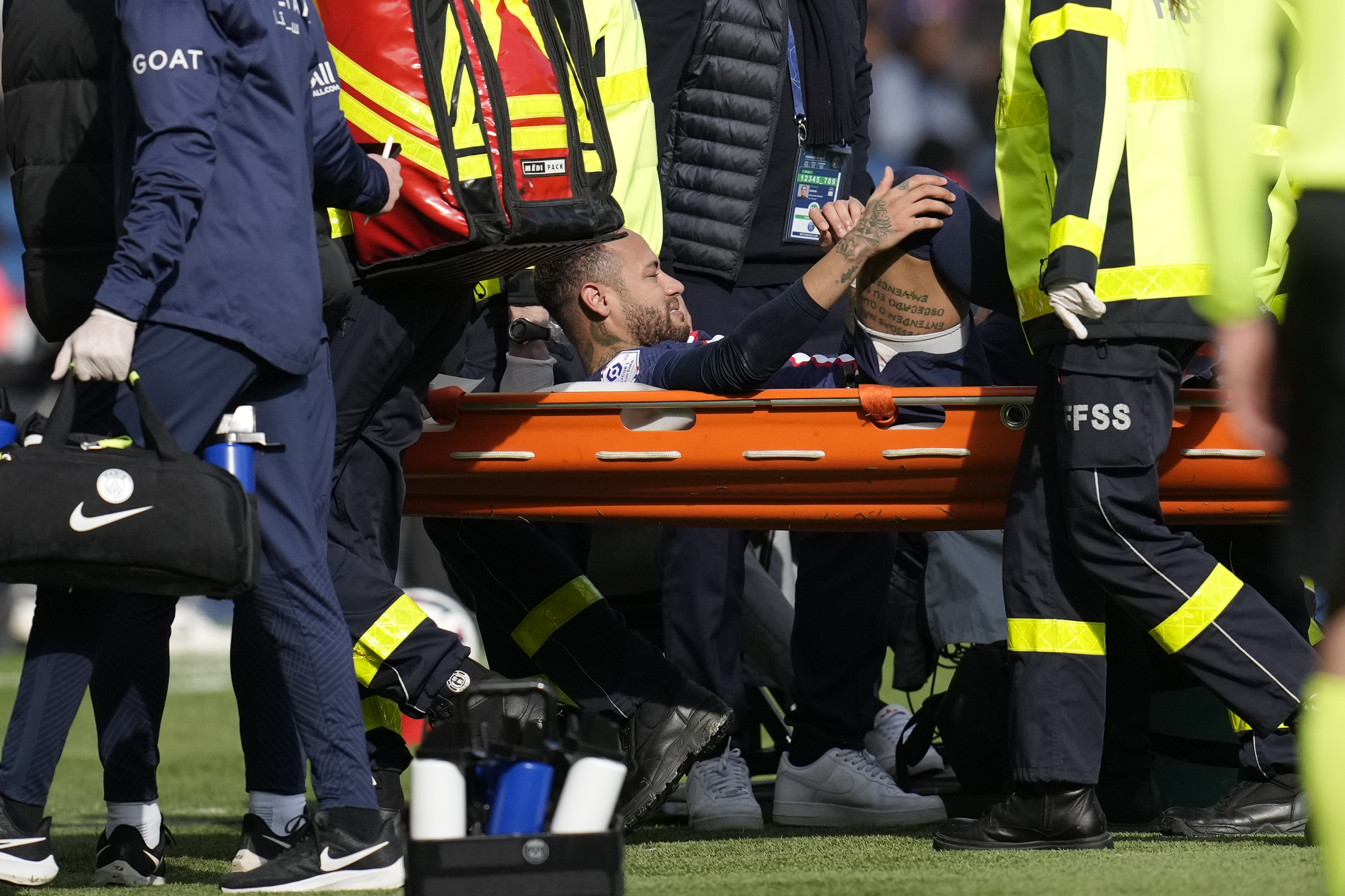 PSG's Neymar is carried off the field on a stretcher after after injuring during the French League One soccer match between Paris Saint-Germain and Lille at the Parc des Princes stadium, in Paris, France, Sunday, Feb. 19, 2023.