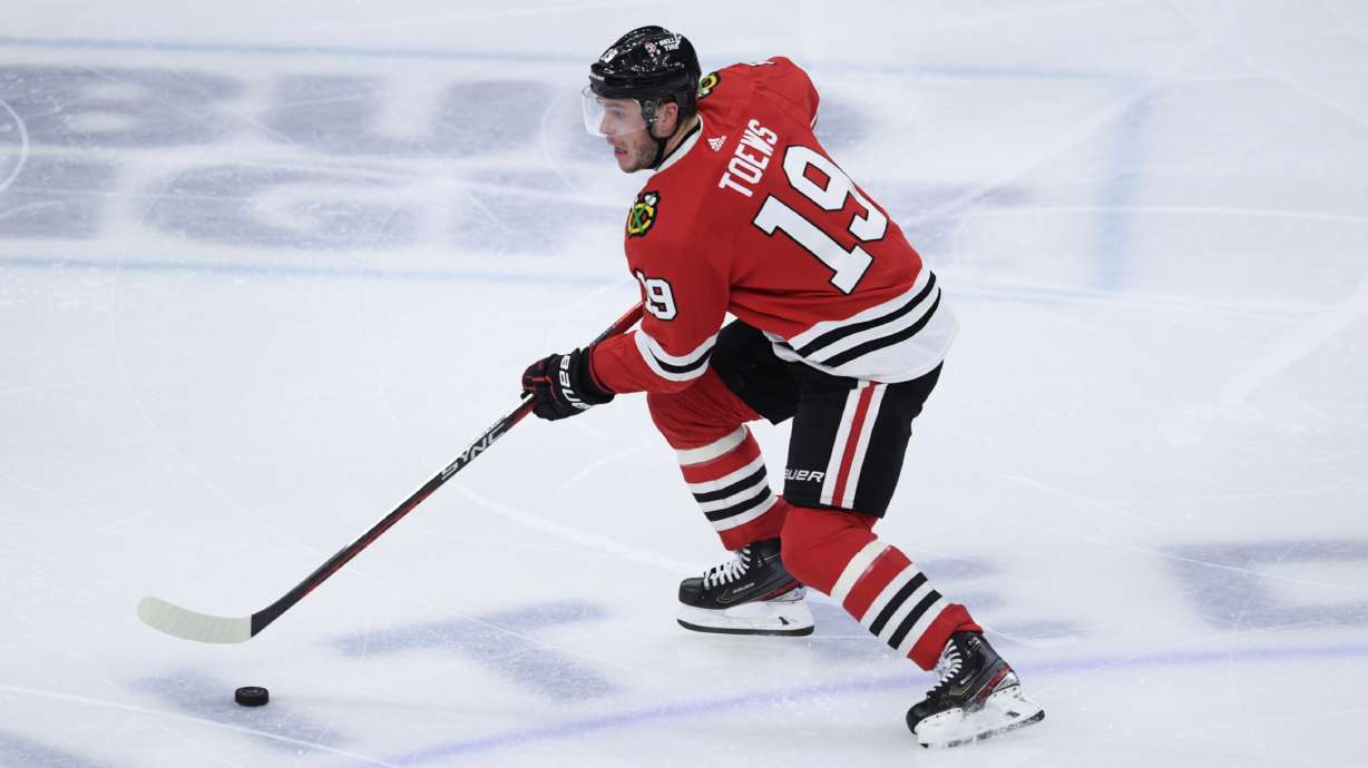 FILE - Chicago Blackhawks' Jonathan Toews (19) moves the puck down ice during the third period of an NHL hockey game against the San Jose Sharks on Jan. 1, 2023, in Chicago. Chicago captain Jonathan Toews and forward Patrick Kane are contemplating their futures ahead of the NHL trade deadline on March 3.