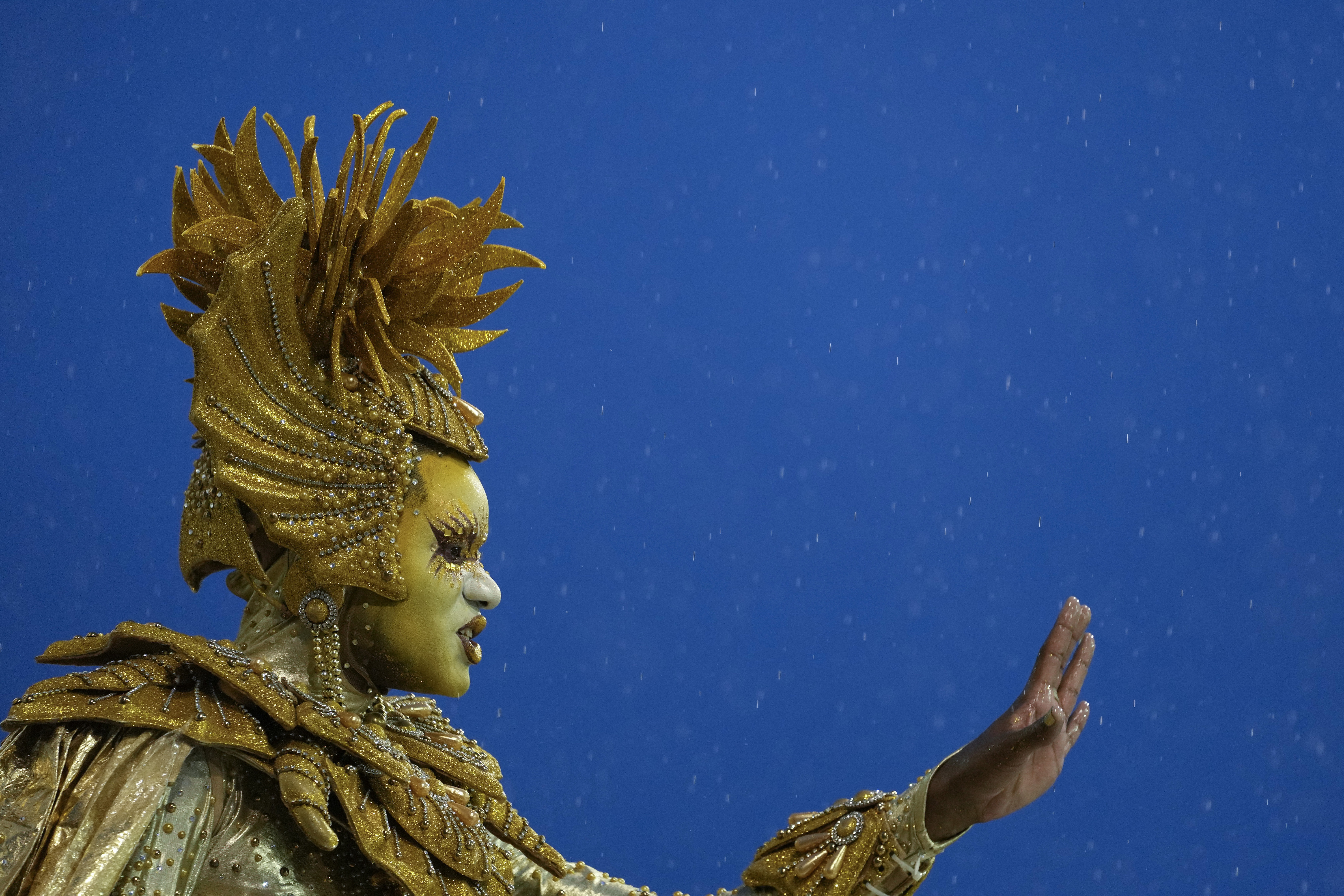 A dancer from the Dragoes da Real samba school performs during a carnival parade in Sao Paulo, Brazil, Sunday, Feb. 19, 2023.