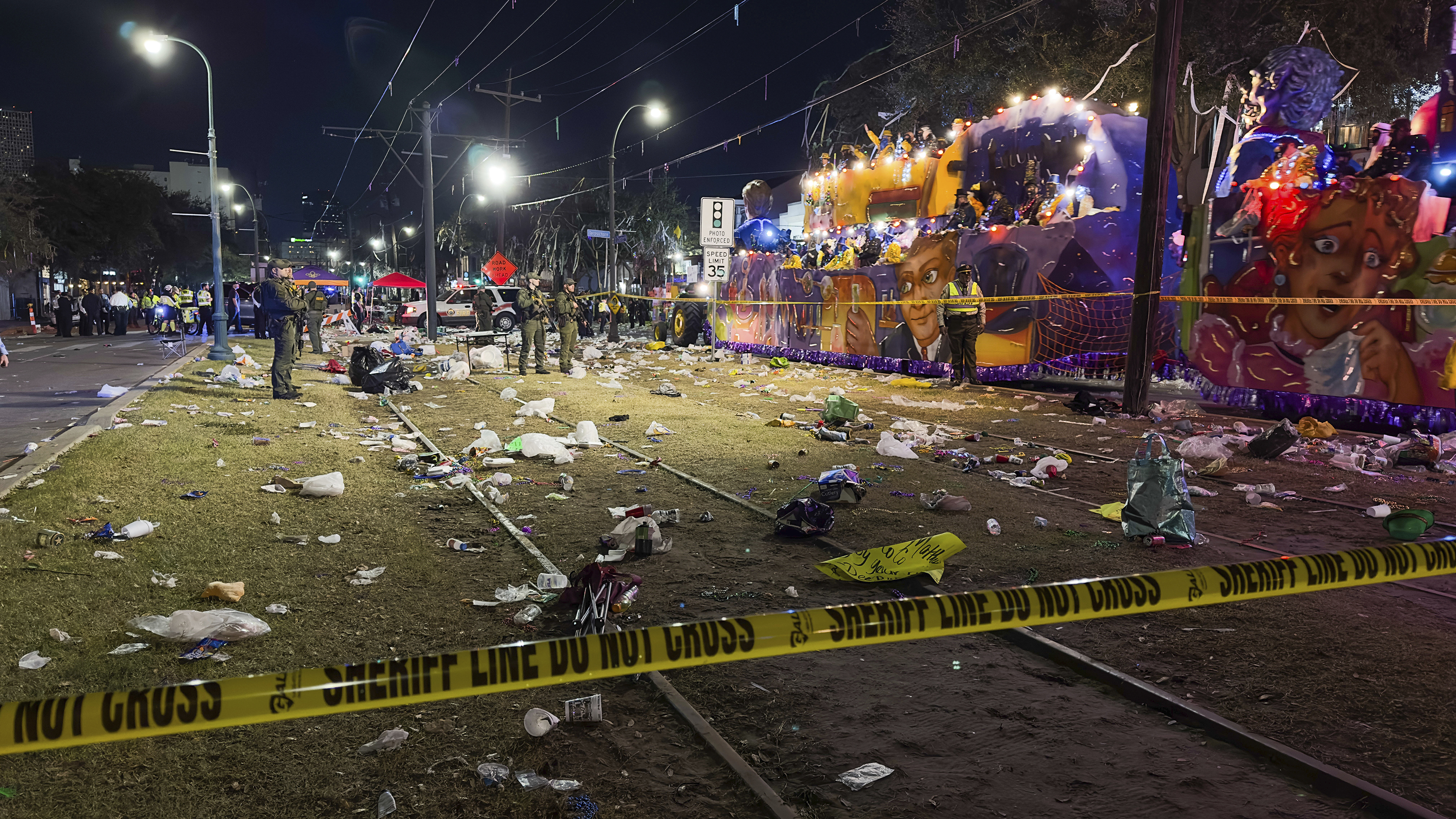 Police work the scene of a shooting at the Krewe of Bacchus parade on Sunday. Five people were shot, including a young girl, during a Mardi Gras parade in New Orleans, police said, and a suspect was in custody. 