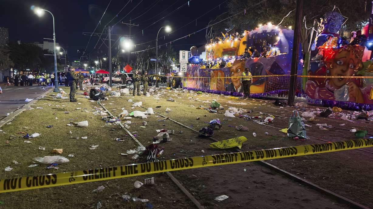 Police work the scene of a shooting at the Krewe of Bacchus parade on Sunday. Five people were shot, including a young girl, during a Mardi Gras parade in New Orleans, police said, and a suspect was in custody.