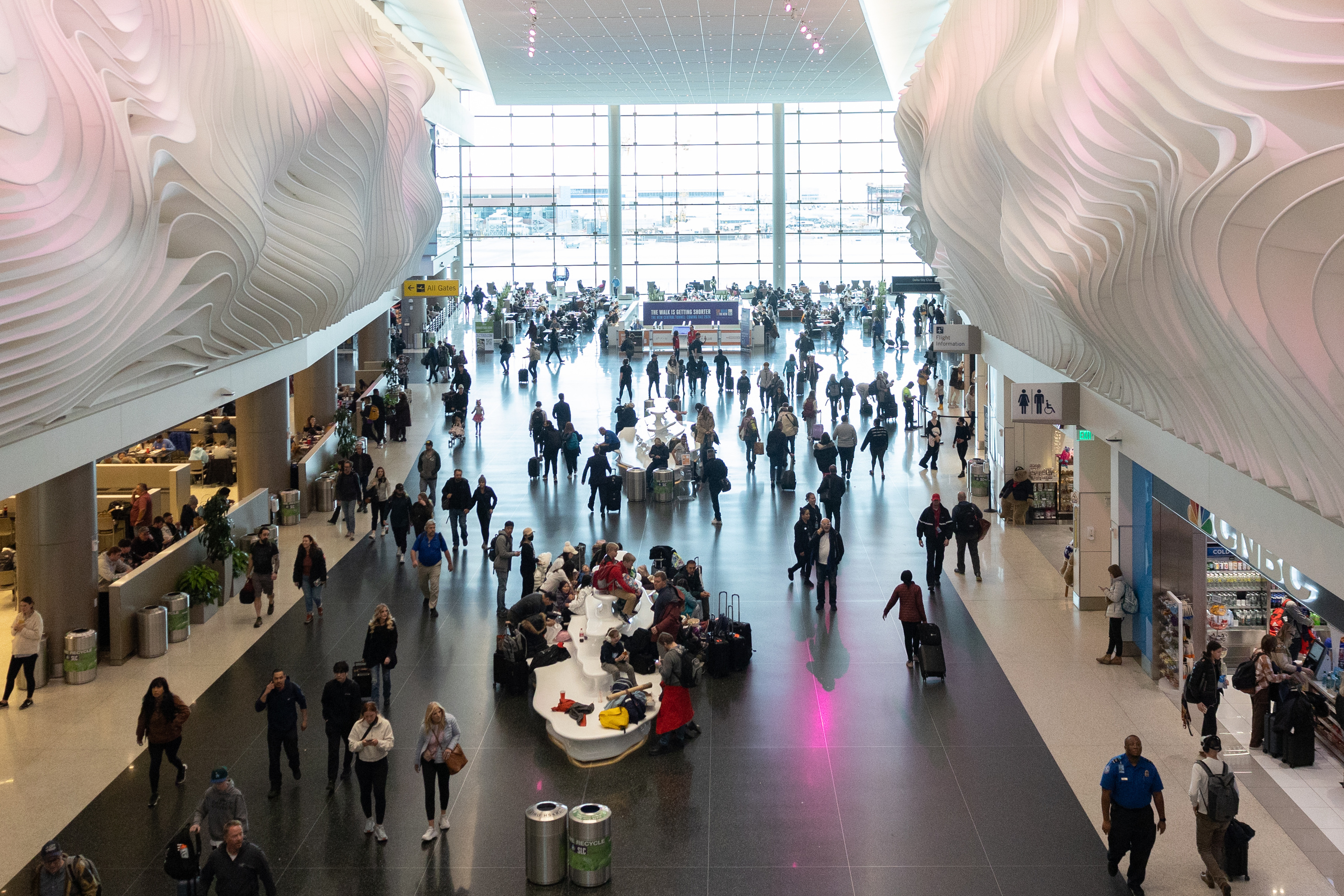 Travelers mill about the main terminal after passing through TSA at Salt Lake City International Airport in Salt Lake City on Monday.