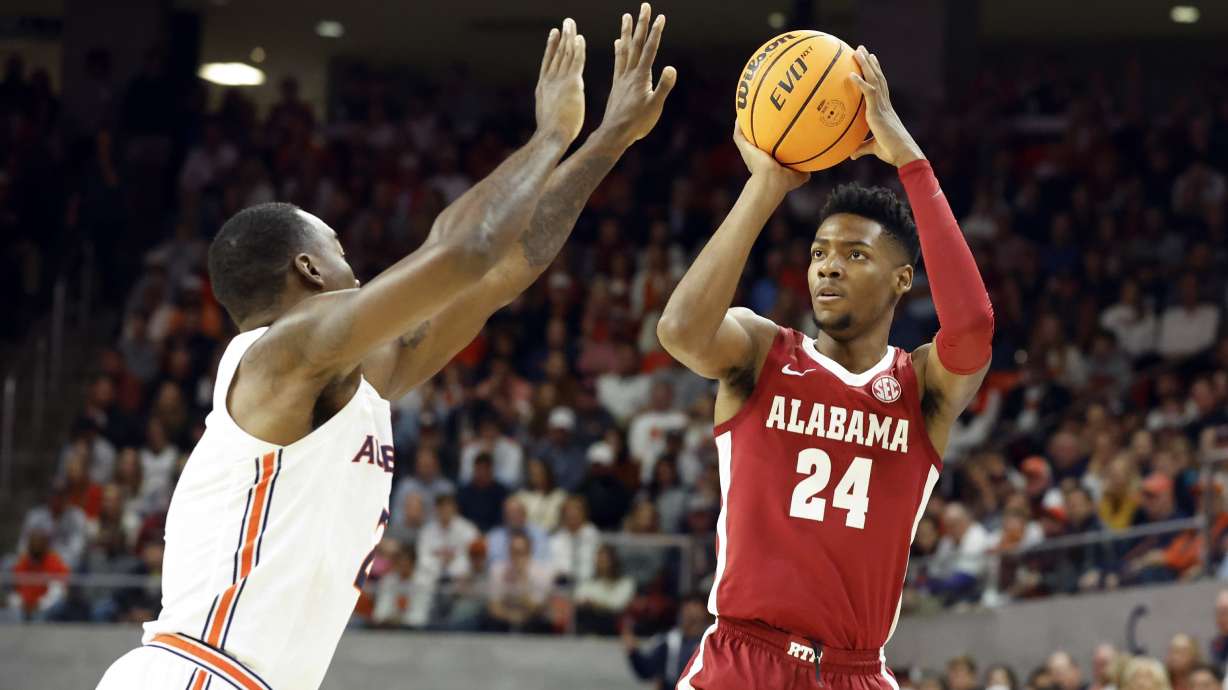 Alabama forward Brandon Miller (24) shoots over Auburn forward Jaylin Williams during the first half of an NCAA college basketball game, Saturday, Feb. 11, 2023, in Auburn, Ala.