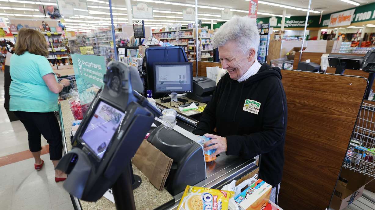 Margaret Tennant checks a customer’s purchases at Ream’s Food Store in Sandy on Sept. 23, 2022.