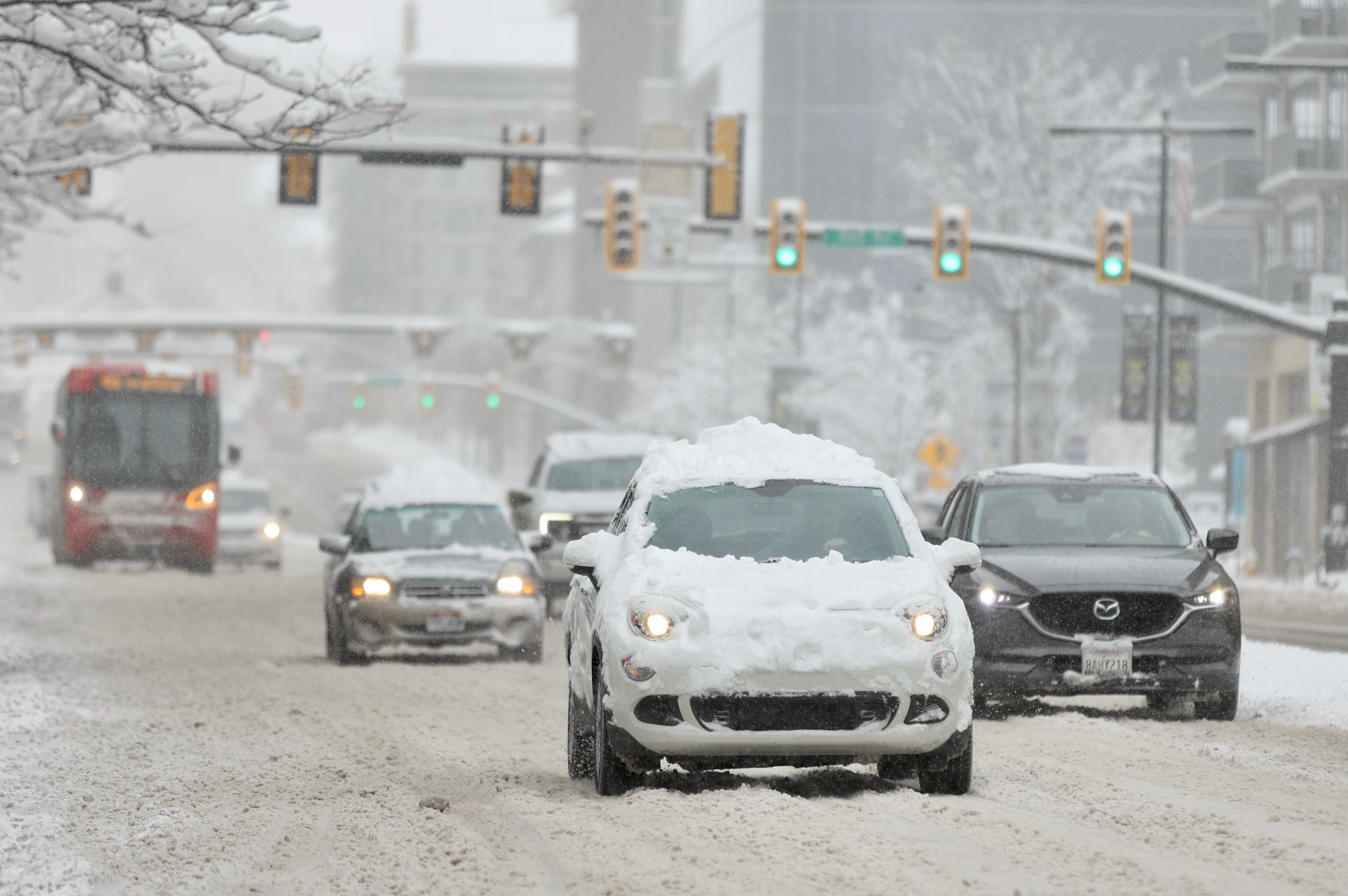 Cars drive on State Street in Salt Lake City during a winter storm on Wednesday. Utah Highway Patrol troopers say they arrested an impaired driver who was driving the wrong way on I-80 during Wednesday morning's snowstorm and doing doughnuts on the freeway.