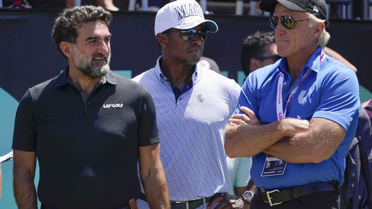 FILE - Yasir Al-Rumayyan, left, governor of Saudi Arabia's Public Investment Fund, Majed Al-Sorour, CEO of Golf Saudi, center, and Greg Norman, CEO of LIV Golf, watch at the first tee during the second round of the Bedminster Invitational LIV Golf tournament in Bedminster, N.J., on July 30, 2022. A federal judge has ruled the head of Saudi Arabia's sovereign wealth fund, the financial backer of LIV Golf, must sit for depositions and produce documents in LIV Golf's antitrust lawsuit against the PGA Tour. Lawyers for the Public Investment Fund and its governor, Yasir al-Rumayyan, had sought to quash subpoenas claiming sovereign immunity.