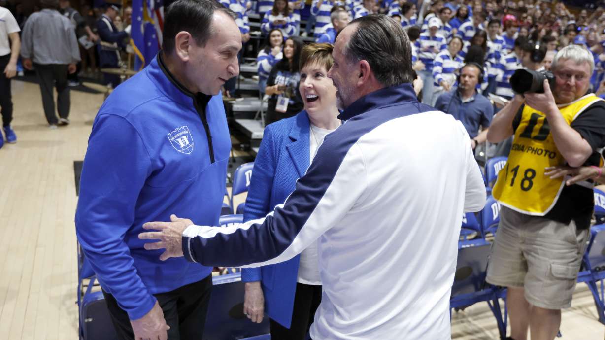 Former Duke head coach Mike Krzyzewski, left, and his wife, Mickie, laugh with Notre Dame head coach Mike Brey, right, before an NCAA college basketball game game in Durham, N.C., Tuesday, Feb. 14, 2023.