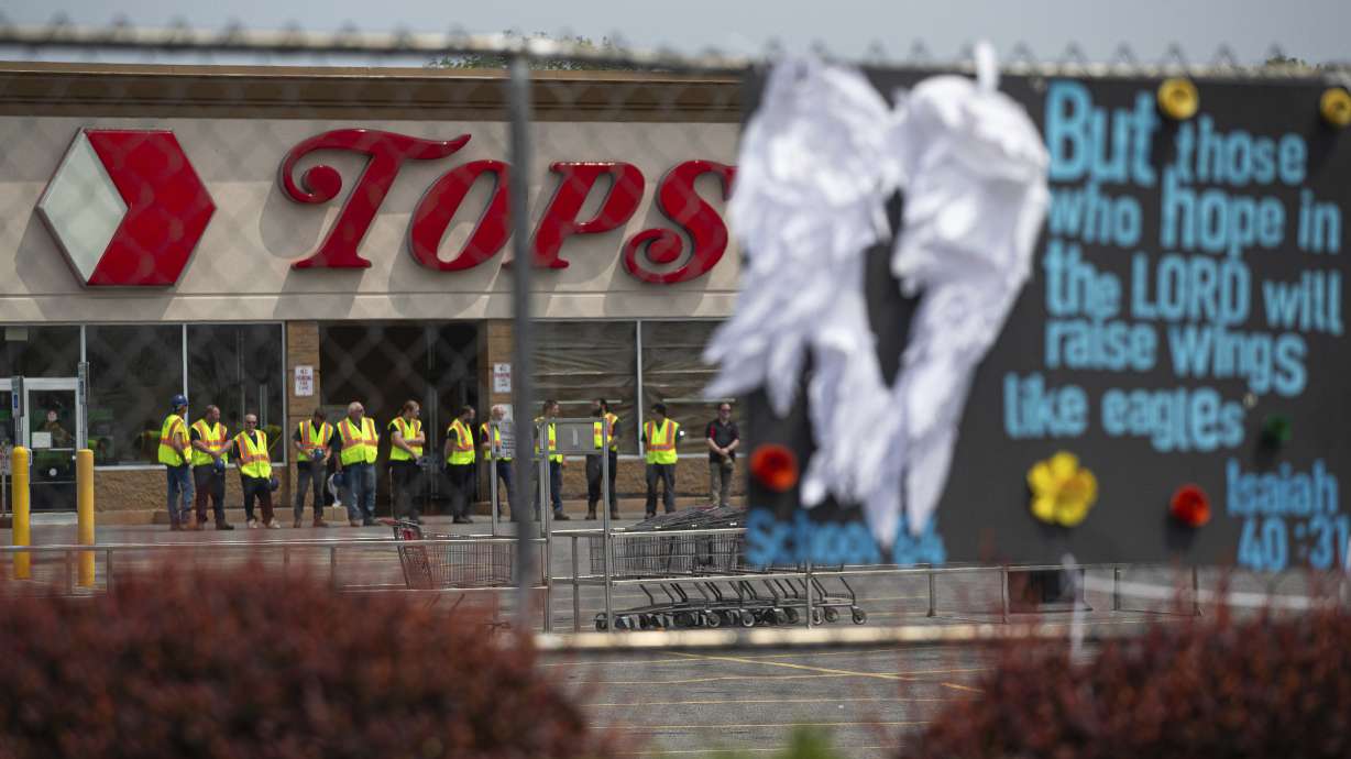 Investigators stand outside during a moment of silence for the victims of the Buffalo supermarket shooting outside the Tops Friendly Market on May 21, 2022, in Buffalo, New York. The number of U.S. mass killings linked to extremism was at least three times higher in the last decade than the total from any 10-year period since the 1970s.