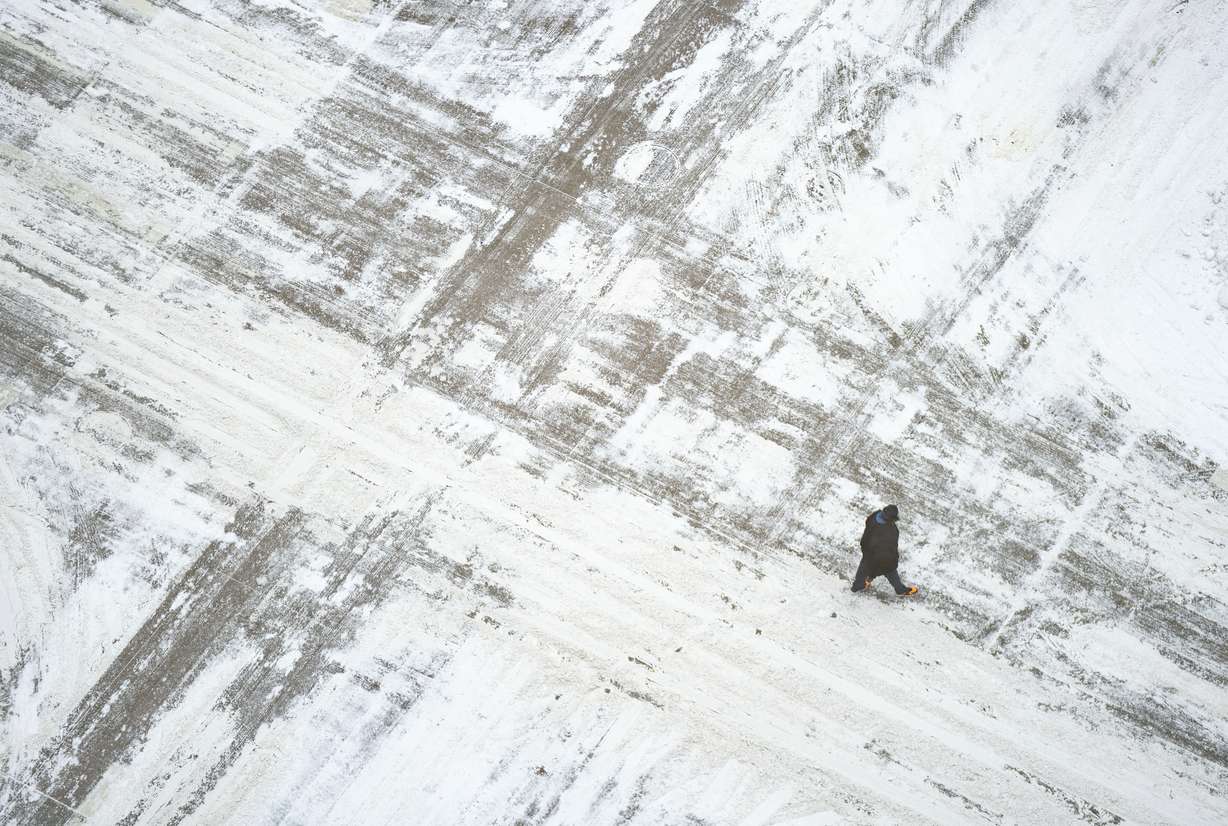 A man crosses a snow covered S. Sixth St. Wednesday, in downtown Minneapolis.