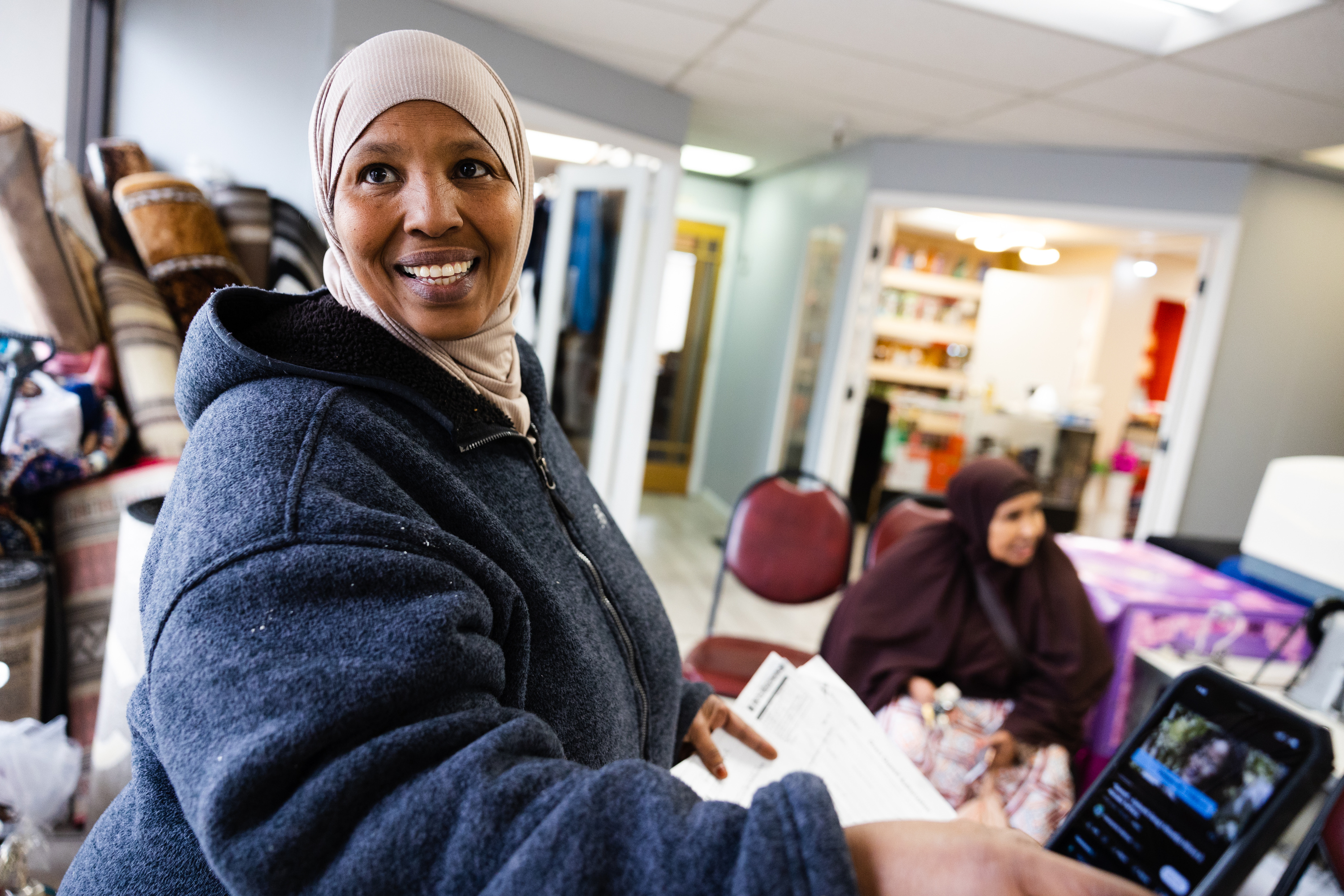Fadumo Abdulkadir shows a video of her friend Khadijah Wasuge at the Somali Community Self Management Agency in Salt Lake City on Jan. 26.