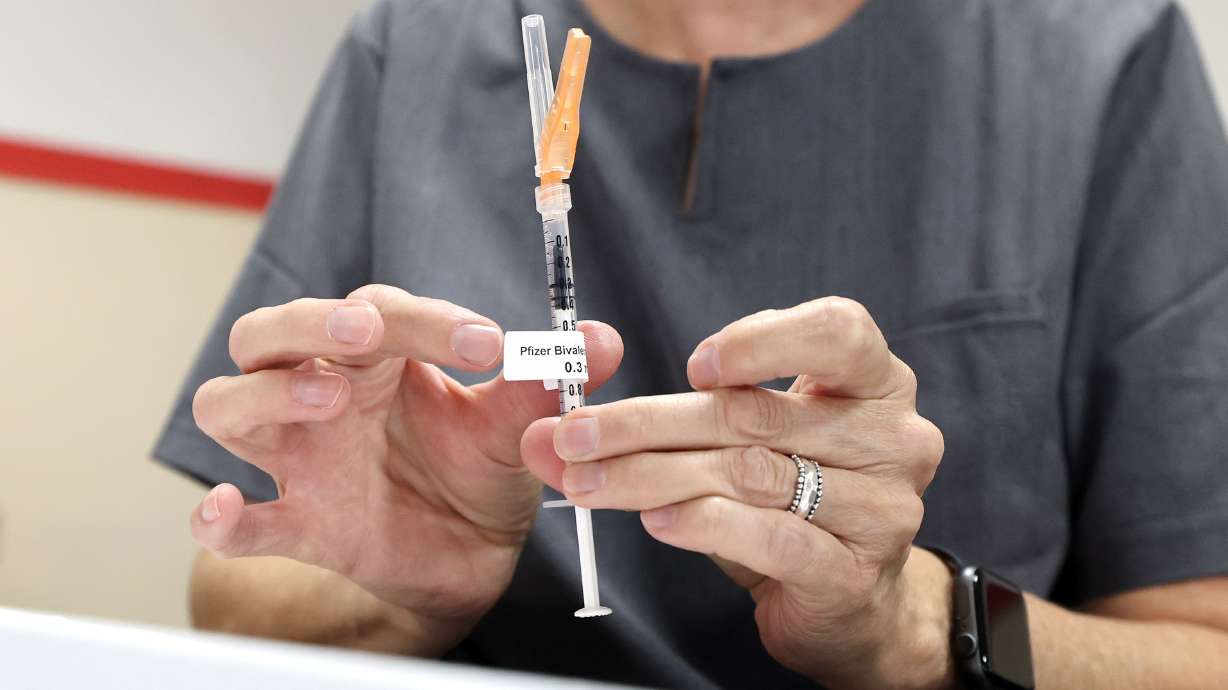 Wendy Dewey, a public health nurse with the Salt Lake County Health Department, prepares a syringe during a free COVID-19 vaccination and testing clinic at the Tongan Methodist Church in West Valley City on Oct. 15, 2022.