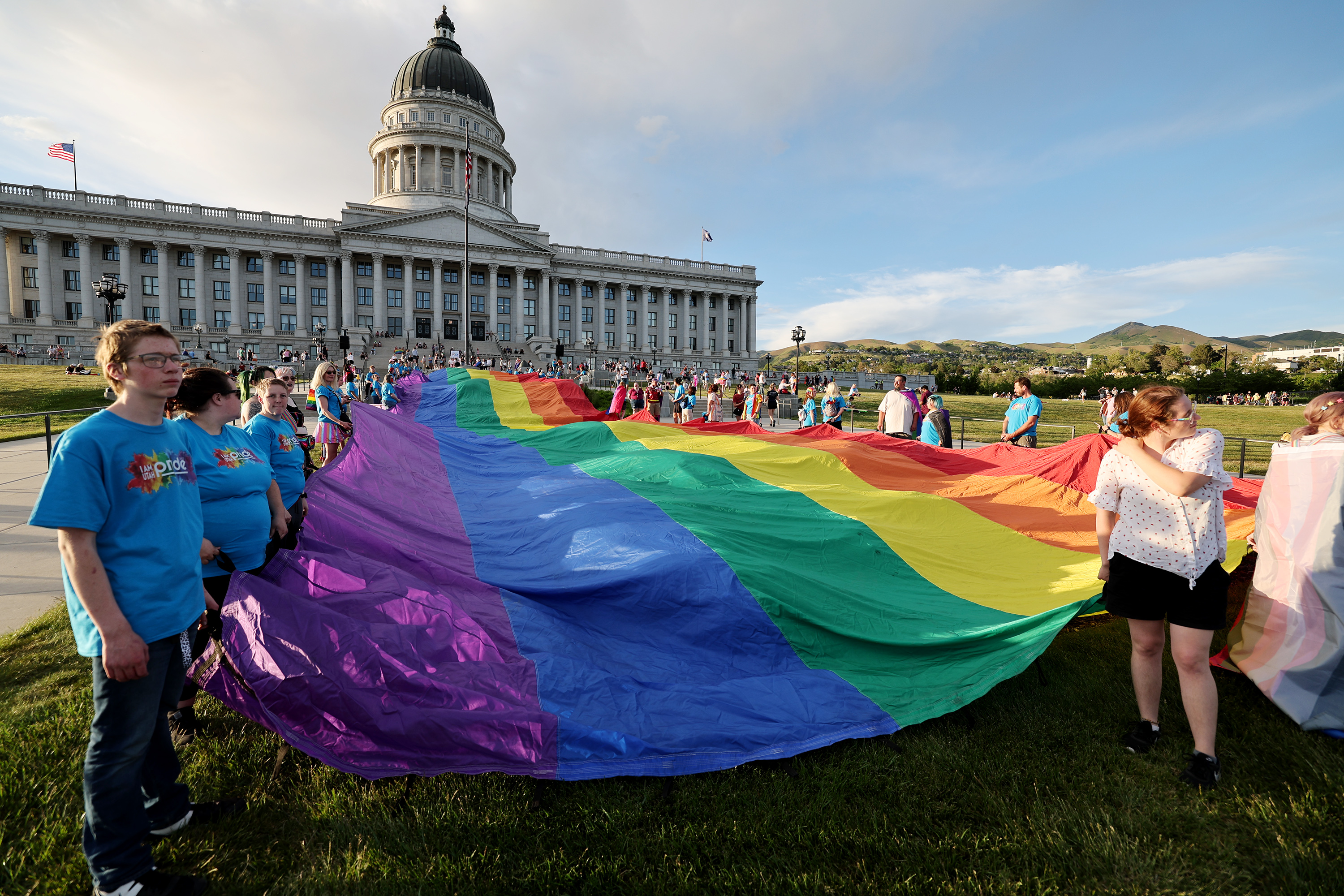 Participants hold a giant rainbow flag as they take part in a rally at the state Capitol in Salt Lake City on June 3, 2022. A bill similar to Florida's so-called "Don't Say Gay" law has been filed in the Utah Legislature.