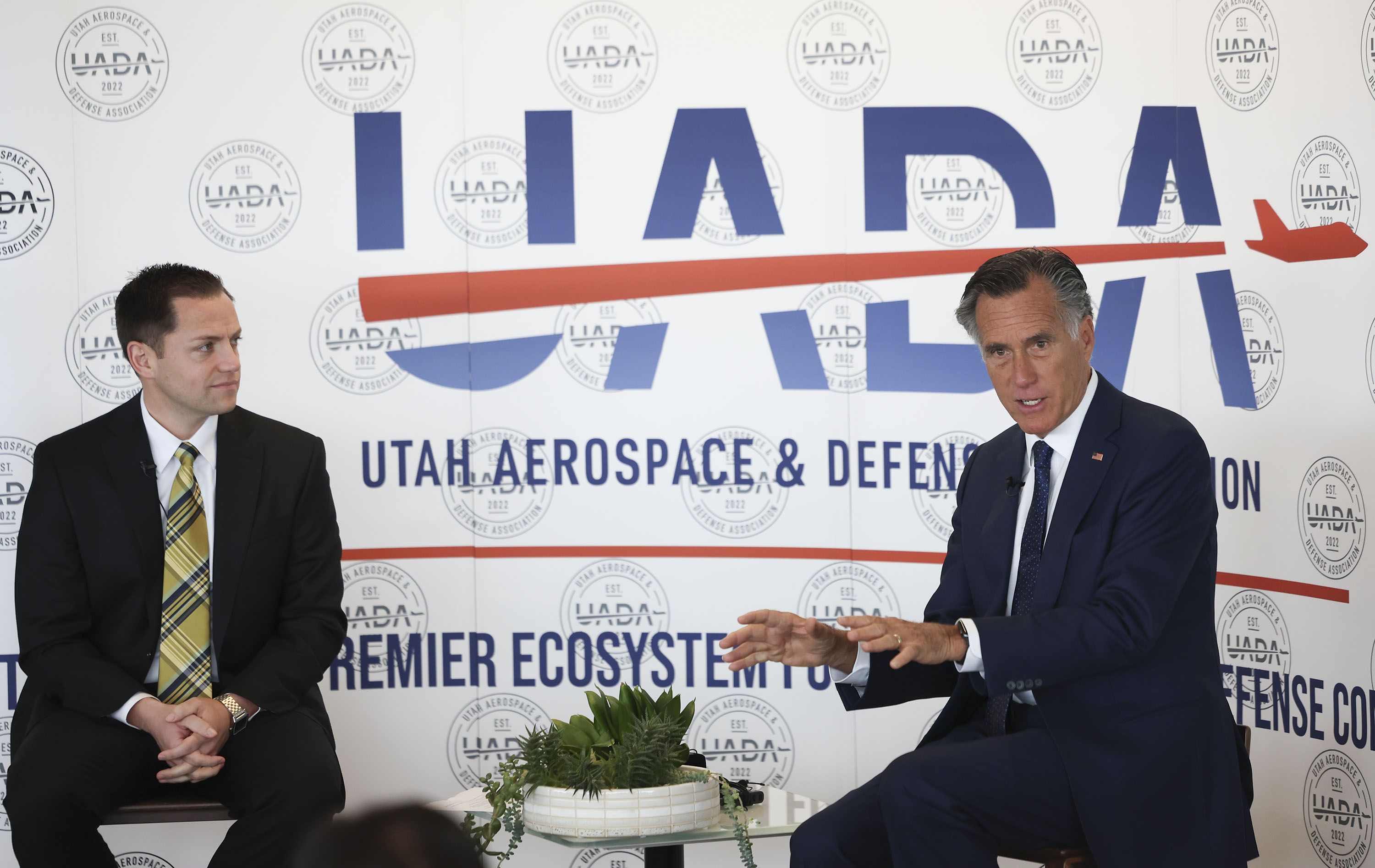 Aaron Starks, president and CEO of the Utah Aerospace and Defense Association, and Sen. Mitt Romney speak at a Utah Aerospace and Defense Association event at the Larry H. Miller Company in Sandy on Thursday.