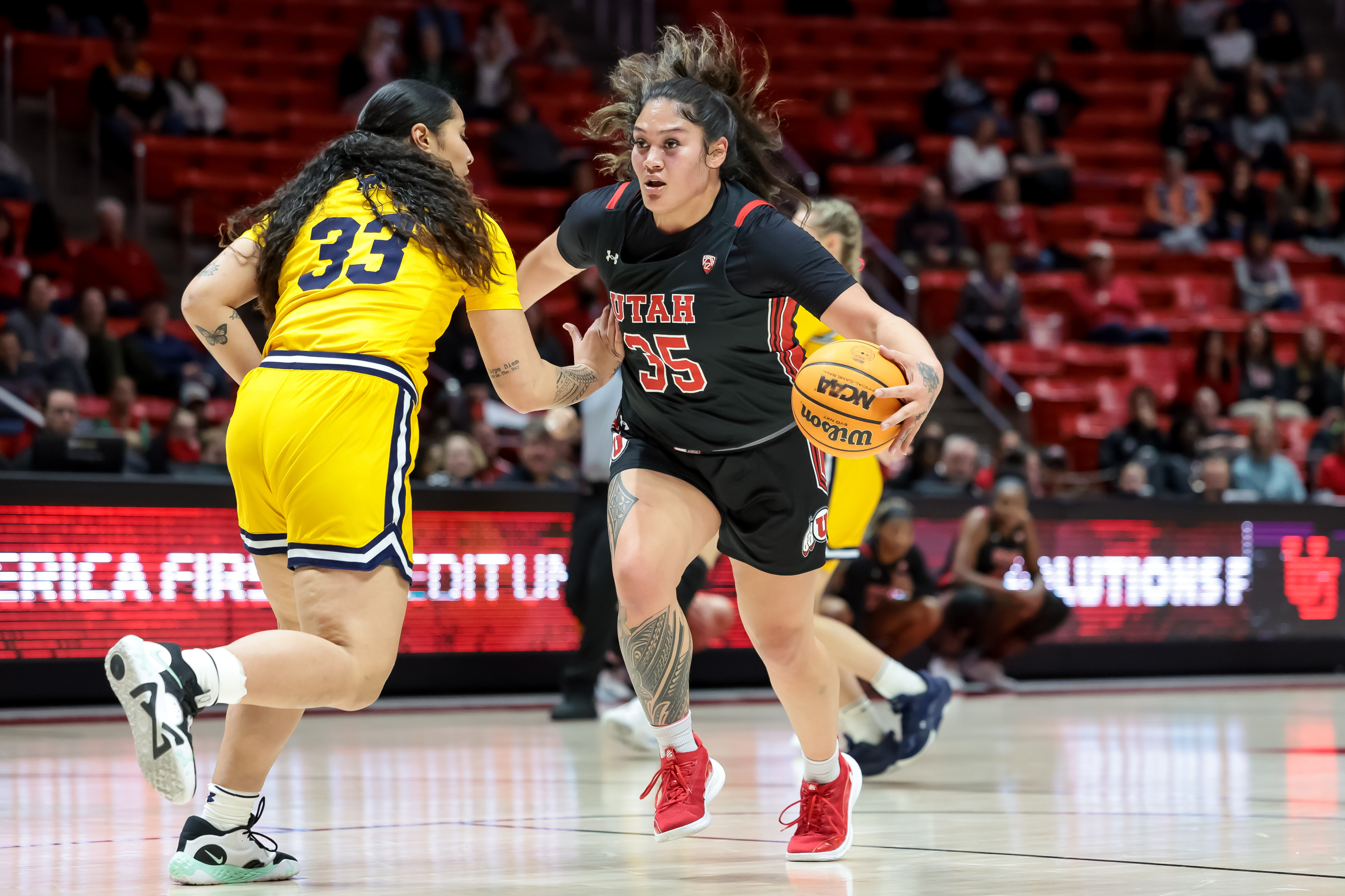 Utah Utes forward Alissa Pili (35) drives against California Golden Bears forward Peanut Tuitele (33) during the game at the Huntsman Center in Salt Lake City on Thursday, Feb. 23, 2023.