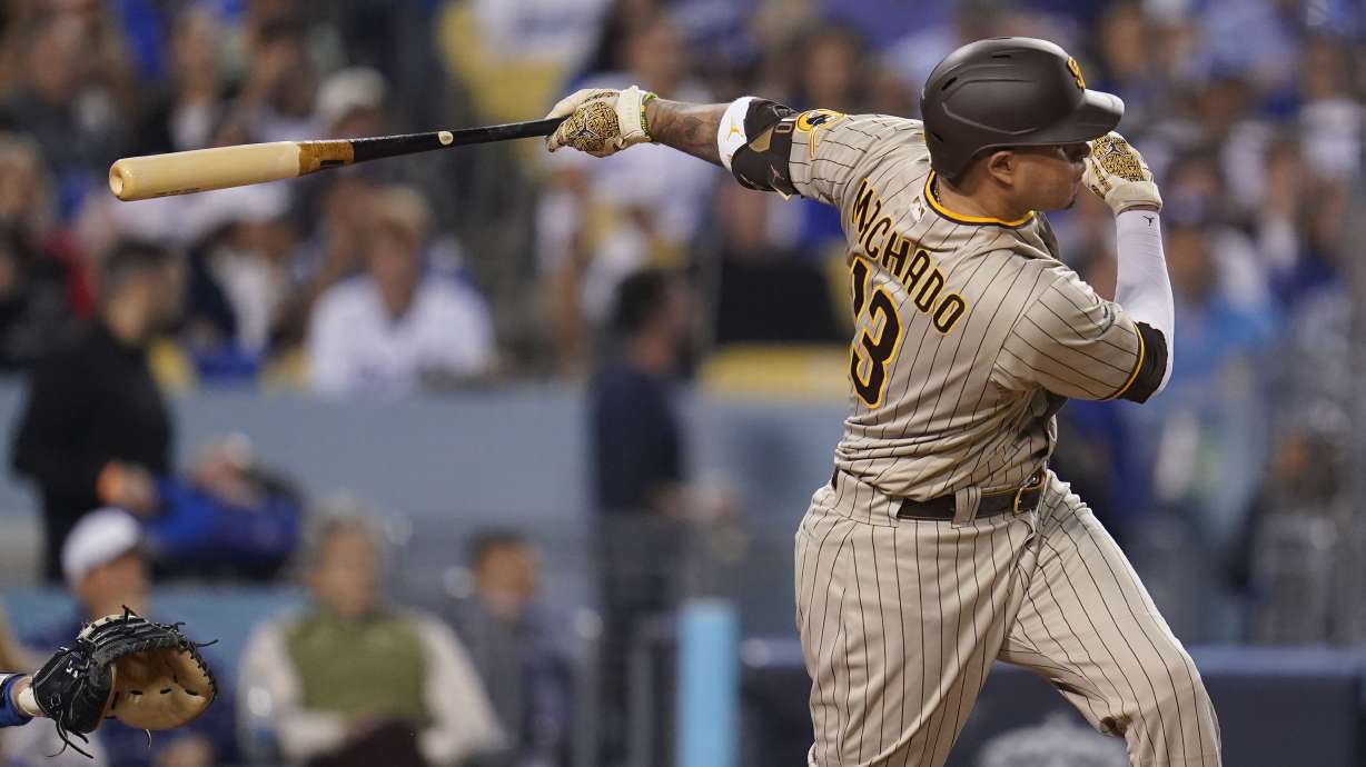 FILE - San Diego Padres' Manny Machado follows through on an RBI-double during the third inning in Game 2 of a baseball NL Division Series against the Los Angeles Dodgers, Oct. 12, 2022, in Los Angeles. Machado and San Diego conclude their season series against Mookie Betts and Los Angeles with the finale of a three-game set Wednesday, Sept. 13, 2023. The Dodgers won the NL West title in 2022 for the ninth time in 10 years, but they were eliminated by the second-place Padres in their NL Division Series.