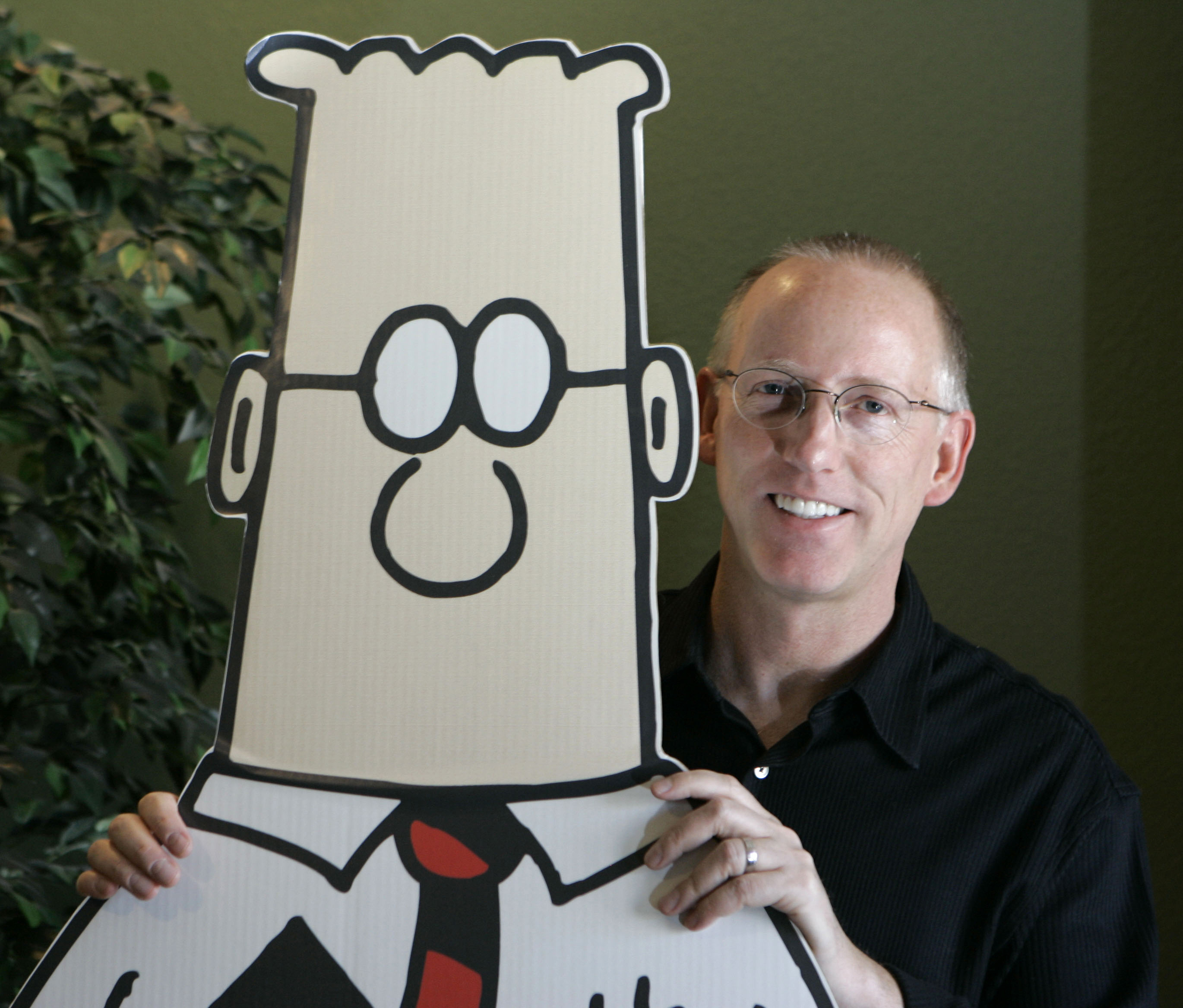 Scott Adams poses for a portrait with the Dilbert character on Oct. 26, 2006. Several media publishers across the U.S. are dropping his Dilbert comic strip after Adams, its creator, described people who are Black as members of “a racist hate group.”
