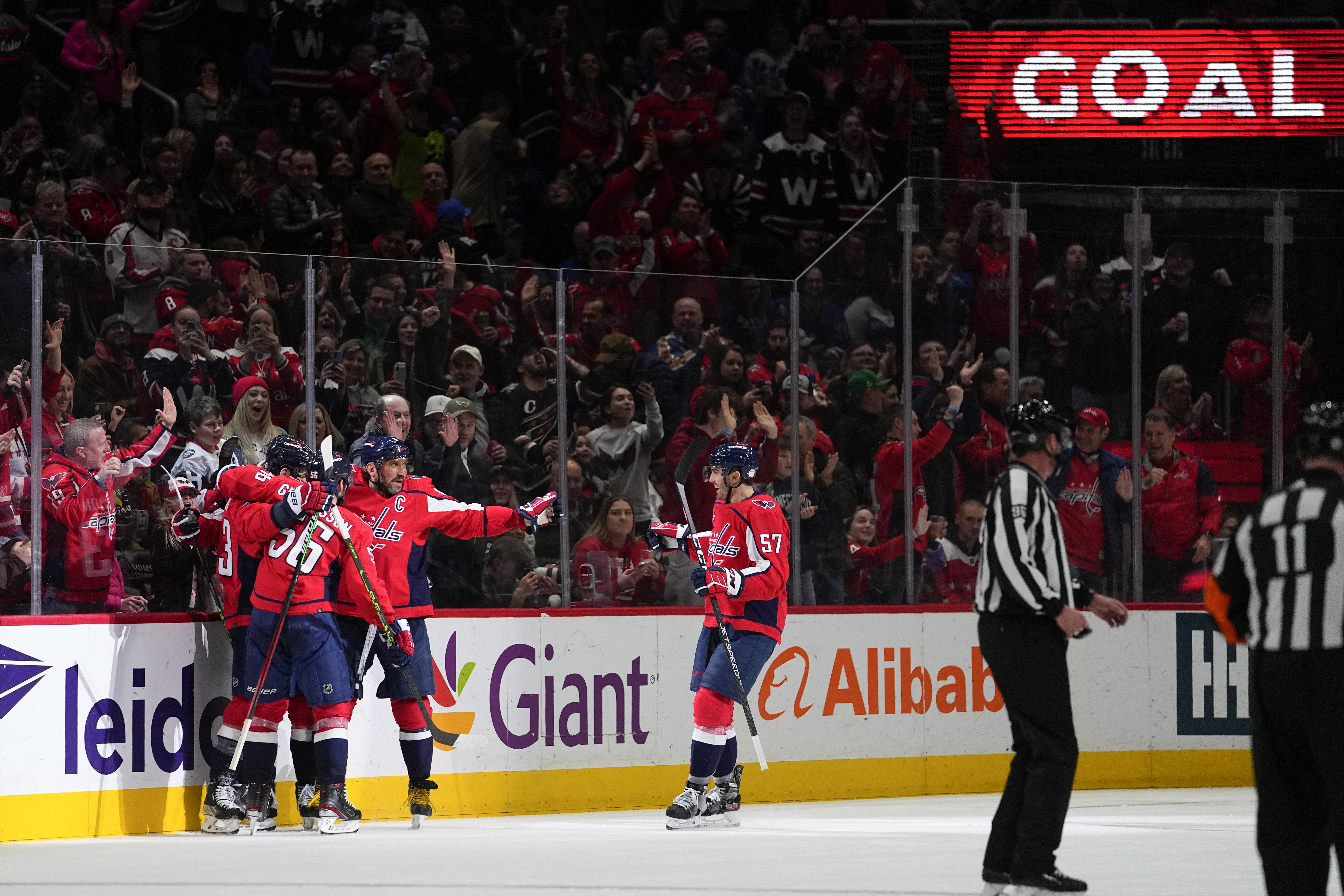 Washington Capitals right wing Tom Wilson (43) celebrates his goal with teammates during the second period of an NHL hockey game against the New York Rangers, Saturday, Feb. 25, 2023, in Washington. 