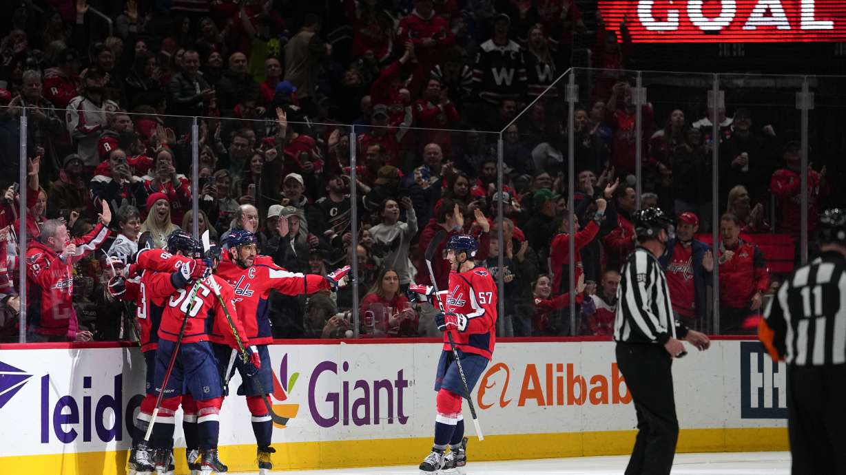 Washington Capitals right wing Tom Wilson (43) celebrates his goal with teammates during the second period of an NHL hockey game against the New York Rangers, Saturday, Feb. 25, 2023, in Washington.