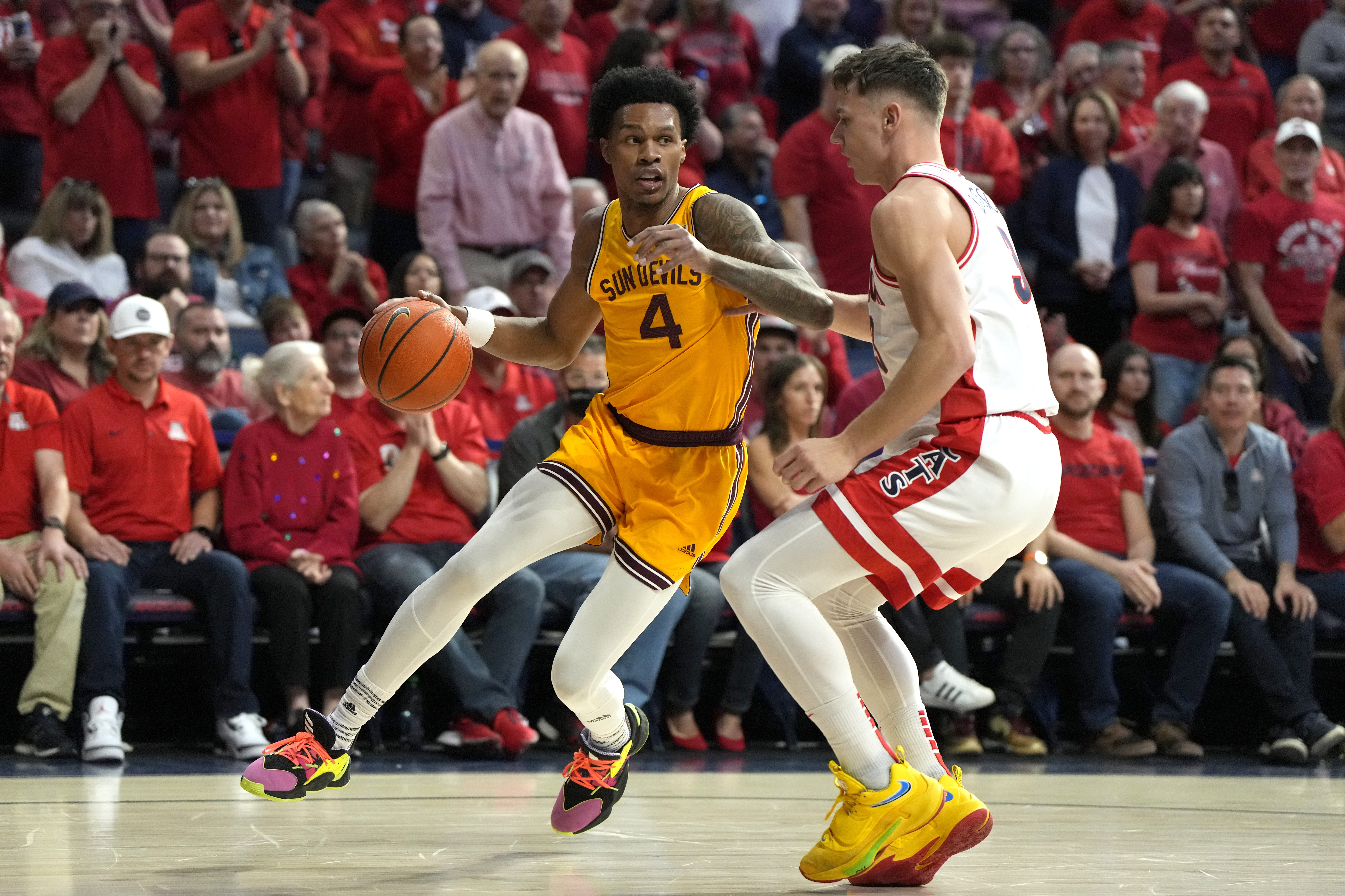 Arizona State guard Desmond Cambridge Jr. (4) drives on Arizona guard Pelle Larsson during the first half of an NCAA college basketball game, Saturday, Feb. 25, 2023, in Tucson, Ariz. 