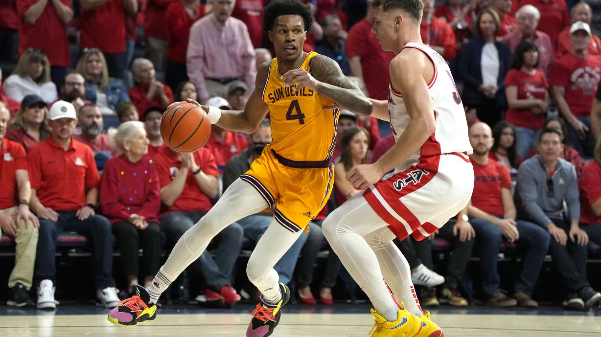 Arizona State guard Desmond Cambridge Jr. (4) drives on Arizona guard Pelle Larsson during the first half of an NCAA college basketball game, Saturday, Feb. 25, 2023, in Tucson, Ariz.