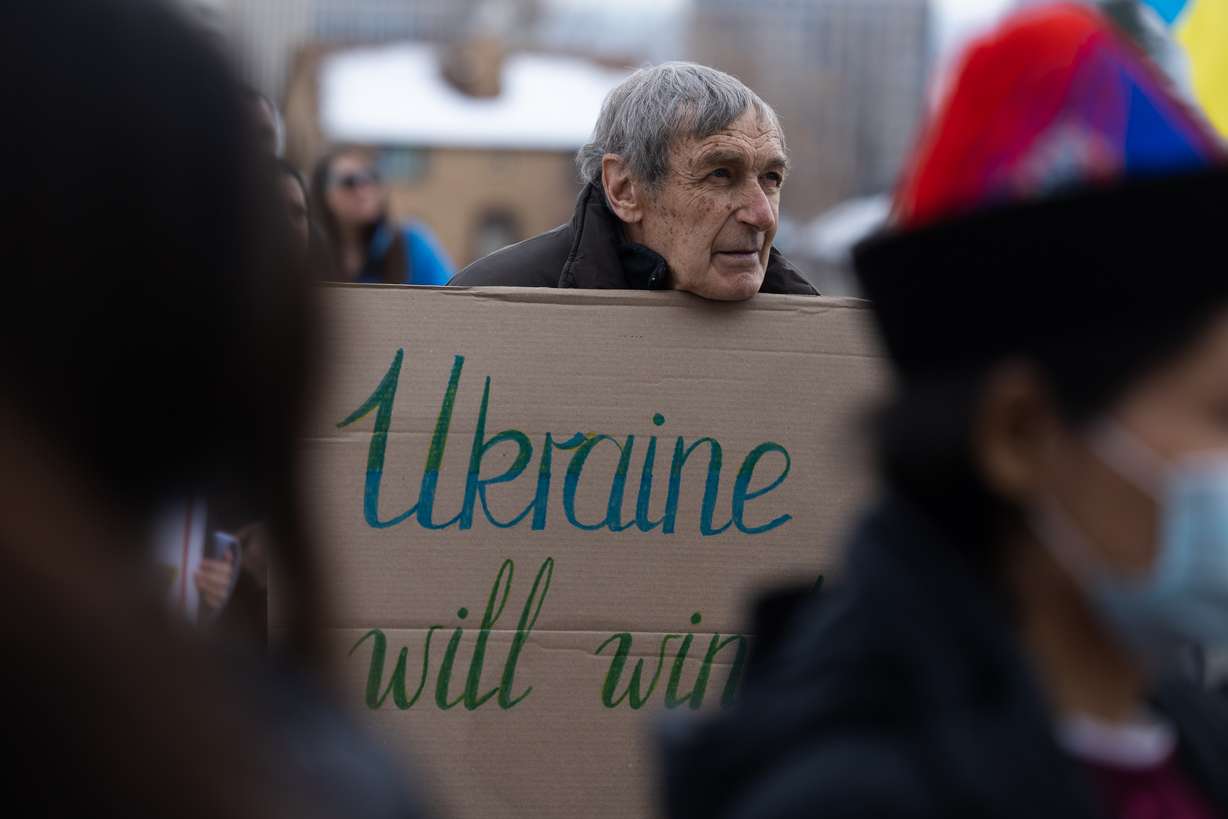 Oleksander Nikolaichuk holds a sign during a rally commemorating the one-year anniversary of the Ukraine-Russia war, at the state Capitol in Salt Lake City on Saturday.