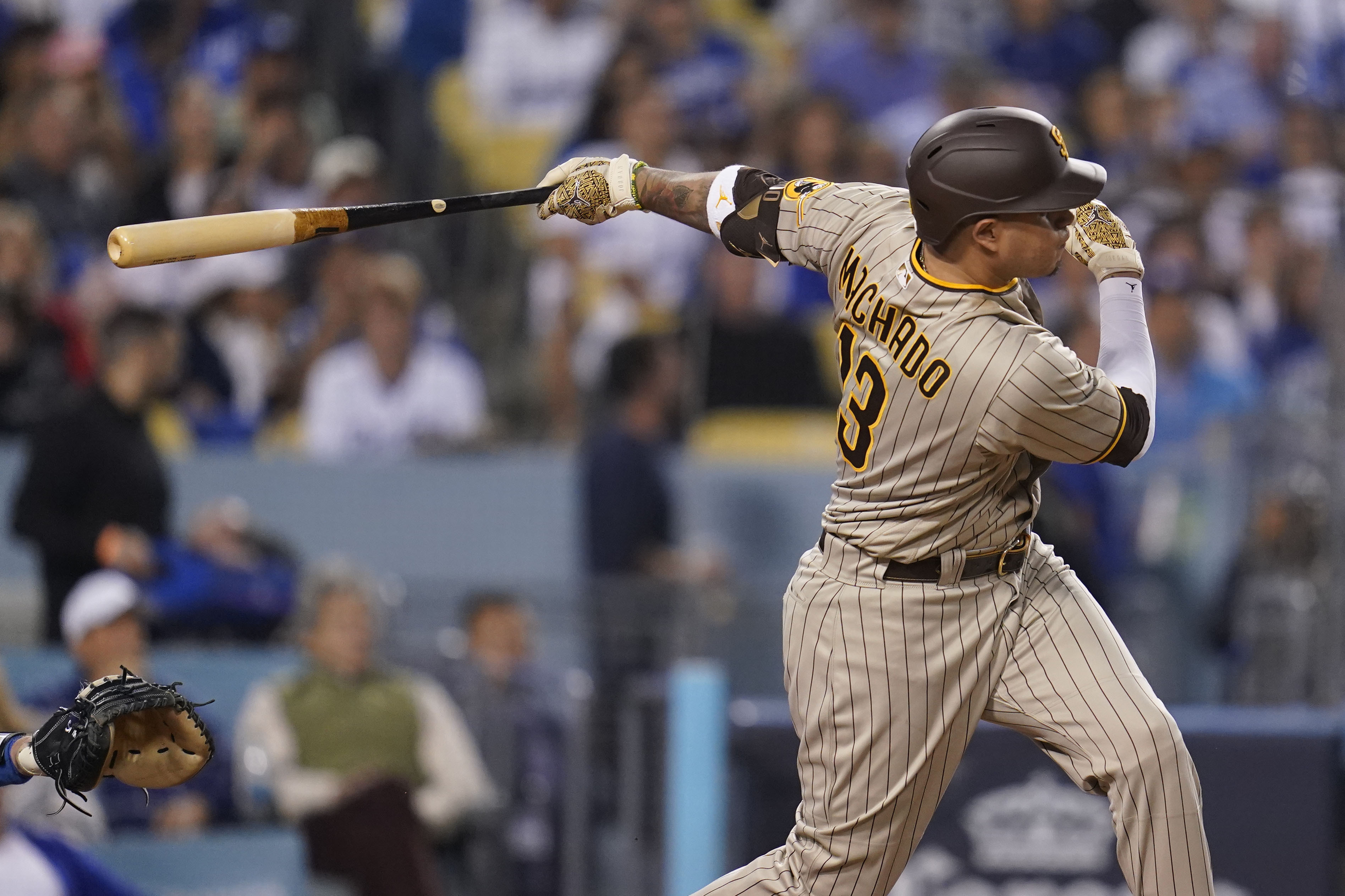 FILE - San Diego Padres' Manny Machado follows through on an RBI-double during the third inning in Game 2 of a baseball NL Division Series against the Los Angeles Dodgers, Oct. 12, 2022, in Los Angeles. Machado and San Diego conclude their season series against Mookie Betts and Los Angeles with the finale of a three-game set Wednesday, Sept. 13, 2023. The Dodgers won the NL West title in 2022 for the ninth time in 10 years, but they were eliminated by the second-place Padres in their NL Division Series. 