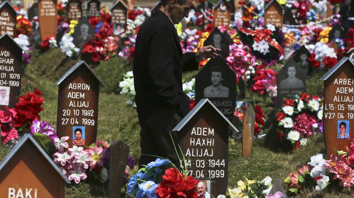 An ethnic Albanian man visits the graves of family members on April 27, 2017, near Gjakova, Kosovo, where Serb forces killed around 370 people in one day during the Kosovo's 1999 war. Around 1,600 people remain missing as a result of the 1998-99 war between ethnic Albanian rebels and Serb forces.