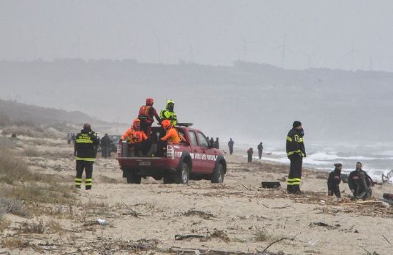 Rescuers recover a body after a suspected migrant boat is wrecked and bodies believed to be of refugees were found in Cutro, the eastern coast of Italy's Calabria region, Italy, Sunday.