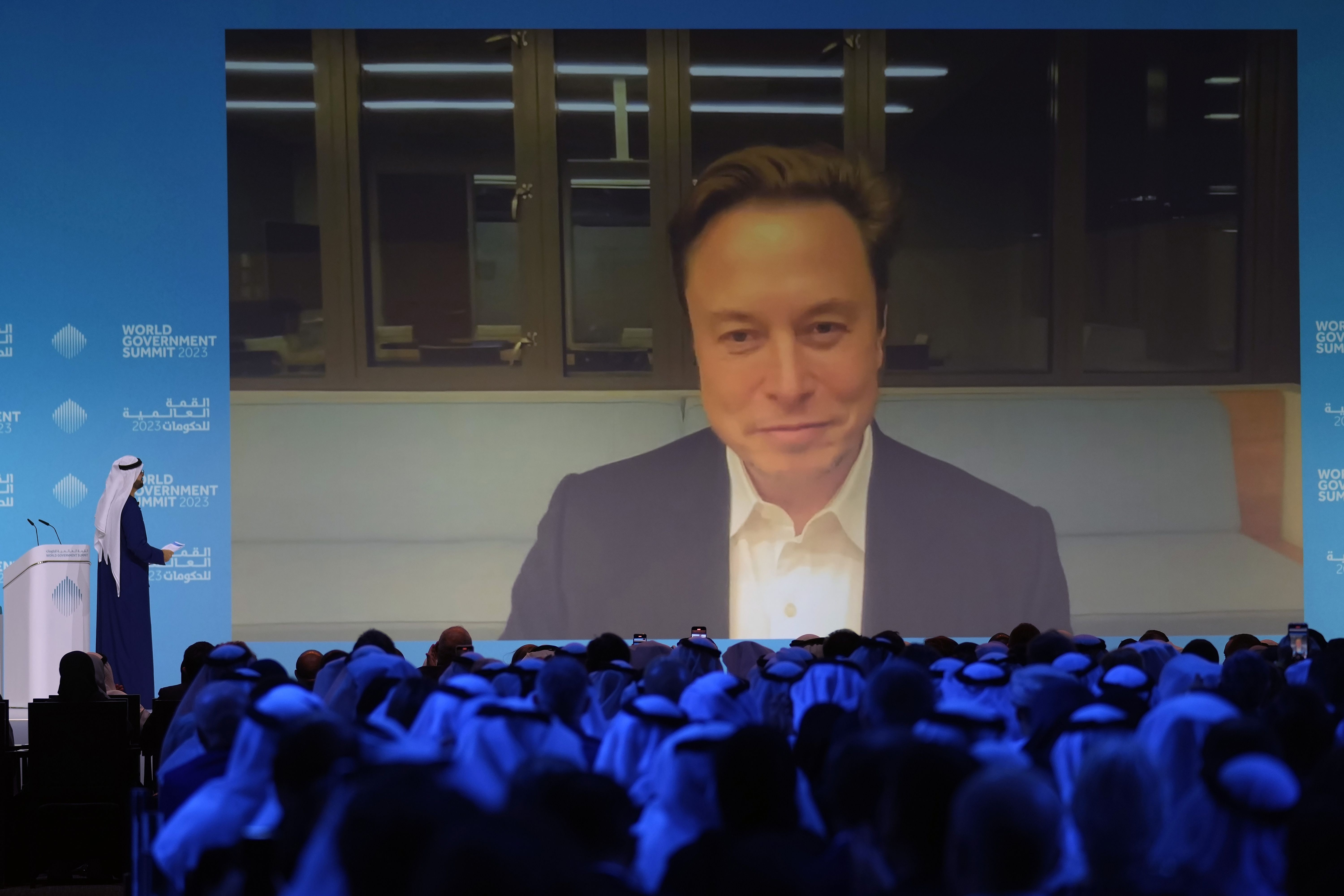 Elon Musk talks virtually to UAE Minister of Cabinet Affairs Mohammad Al Gergawi during the World Government Summit in Dubai, United Arab Emirates, Feb. 15. Musk is interested in building a ChatGPT-style AI engine.