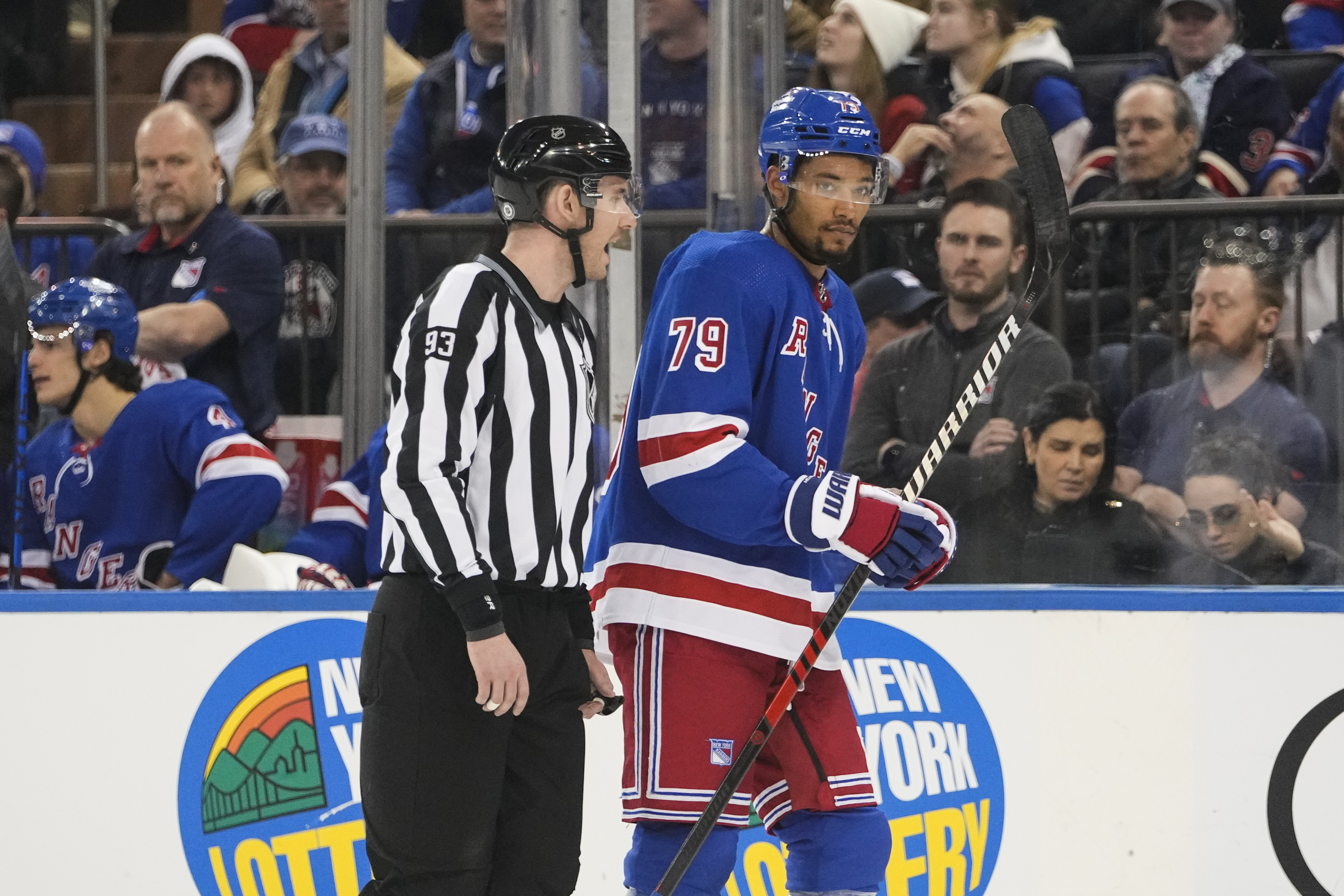 Linesman Kilian McNamara (93) escorts New York Rangers' K'Andre Miller (79) off the ice after Miller received a penalty during the first period of an NHL hockey game against the Los Angeles Kings, Sunday, Feb. 26, 2023, in New York. 