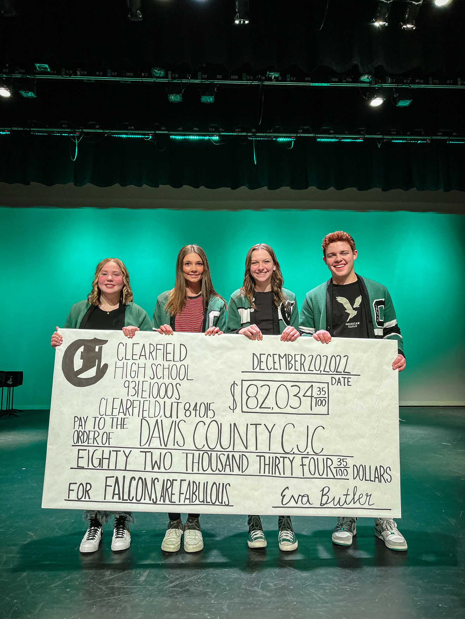 Clearfield High School student body officers Brinley Twitchell, Alissa Austad, Eva Butler and Cole Flinders hold a check representing the entire amount raised by Clearfield High School students for the Davis County Children's Justice Center.