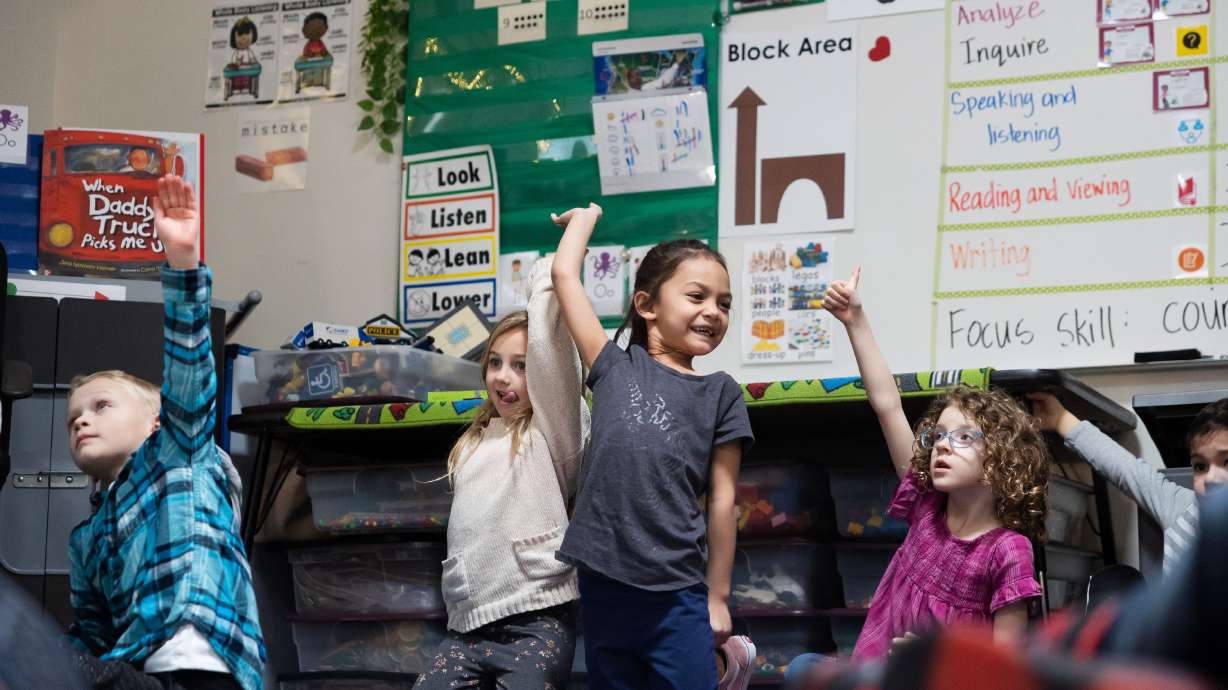 Students raise their hands during a lesson in a full-day kindergarten class at East Sandy Elementary School in Sandy on Monday. A Senate resolution that would ask Utahns whether to amend the Utah Constitution to eliminate the decades' old earmark on income tax revenue for education passed the Utah Senate Tuesday night.