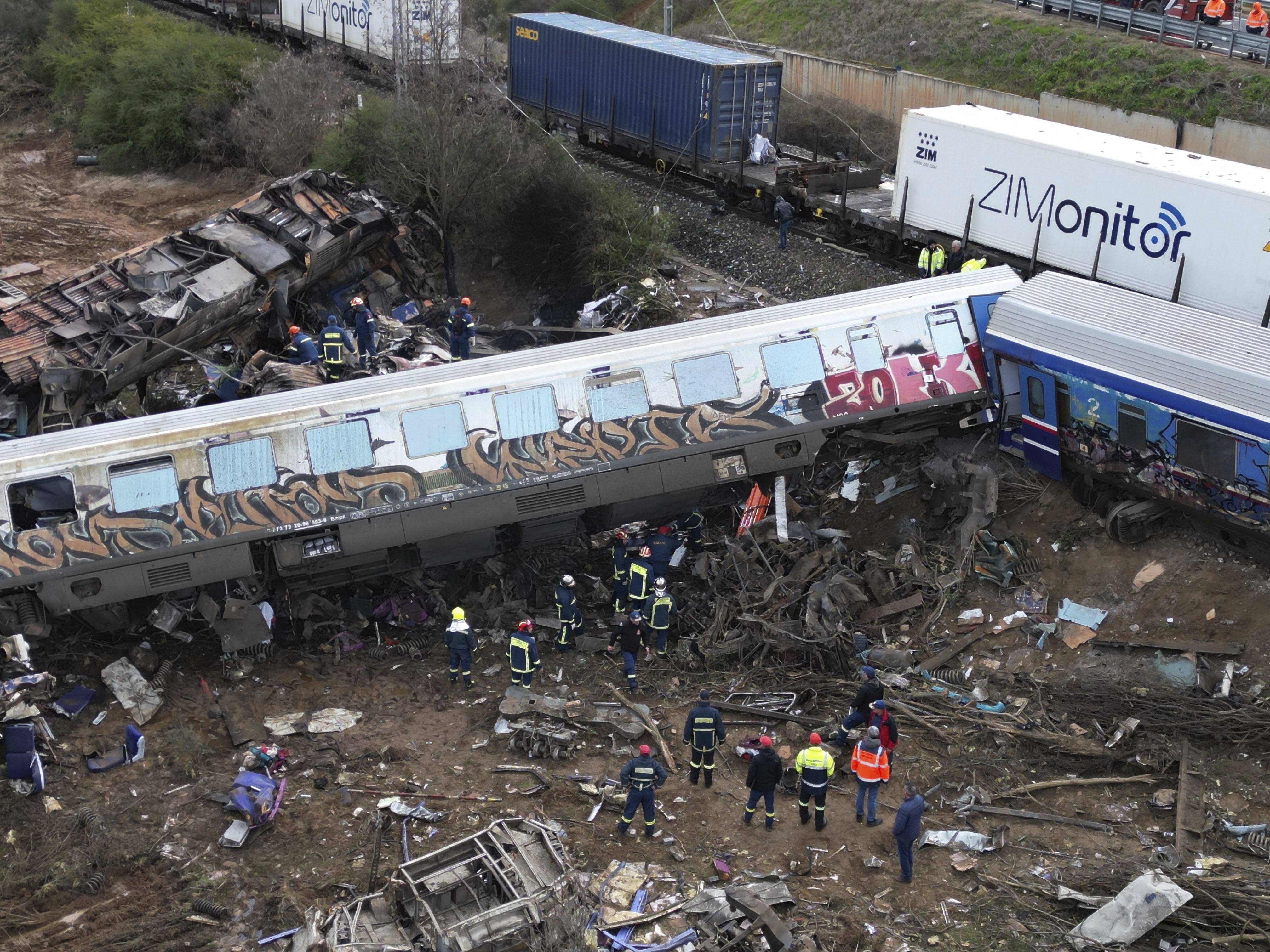 Firefighters and rescuers operate after a collision in Tempe near Larissa city, Greece, Wednesday. A train carrying hundreds of passengers has collided with an oncoming freight train, killing and injuring dozens passengers.