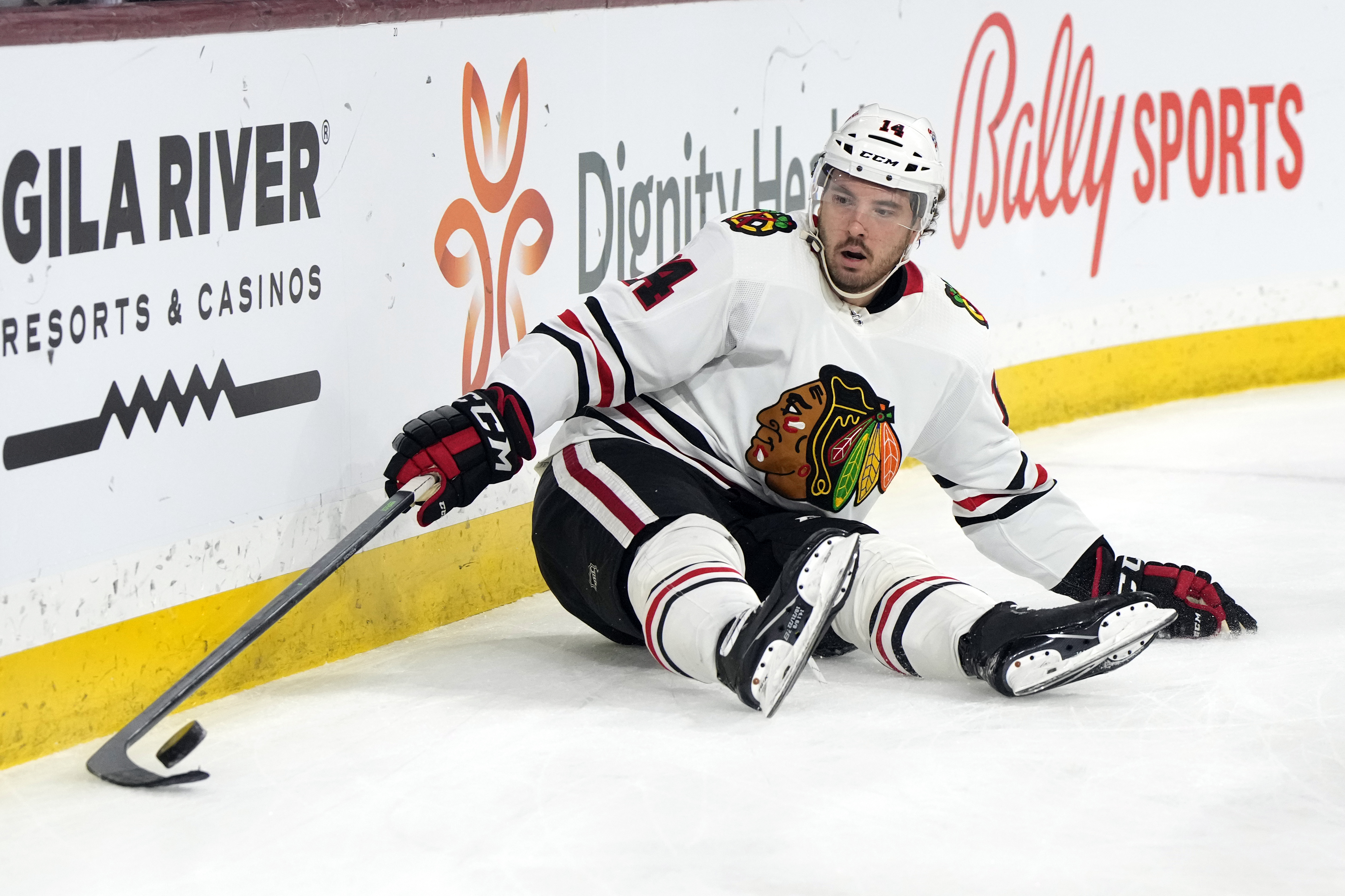 Chicago Blackhawks left wing Boris Katchouk tries to gather the puck after falling down in the second period during an NHL hockey game against the Arizona Coyotes, Tuesday, Feb. 28, 2023, in Tempe, Ariz. 