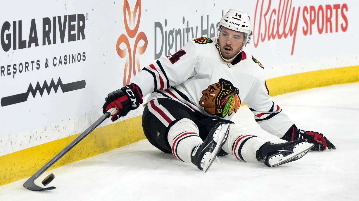 Chicago Blackhawks left wing Boris Katchouk tries to gather the puck after falling down in the second period during an NHL hockey game against the Arizona Coyotes, Tuesday, Feb. 28, 2023, in Tempe, Ariz.
