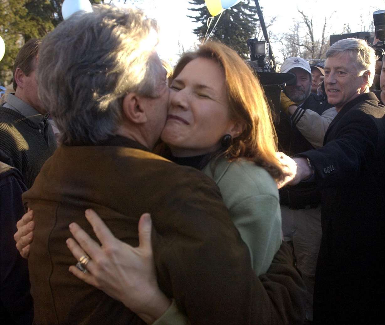 Lois Smart hugs "America's Most Wanted" host John Walsh prior to the beginning of the welcome home party for her daughter, Elizabeth Smart, at Liberty Park on March 14, 2003, in Salt Lake City.