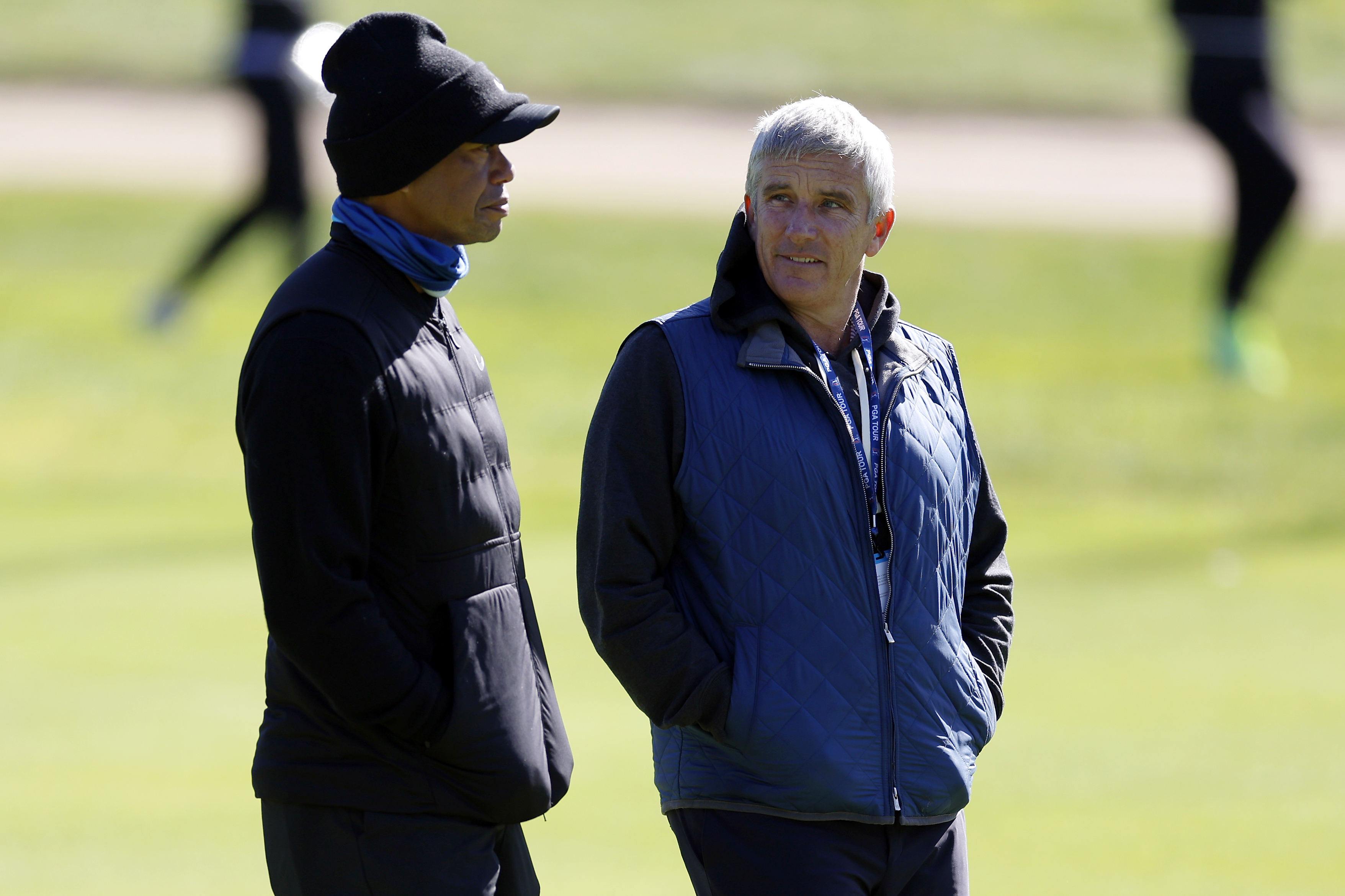 Tiger Woods, left, talks to PGA Commissioner Jay Monahan on the 15th hole during the pro-am of the Genesis Invitational golf tournament at Riviera Country Club, Wednesday, Feb. 15, 2023, in the Pacific Palisades area of Los Angeles. 