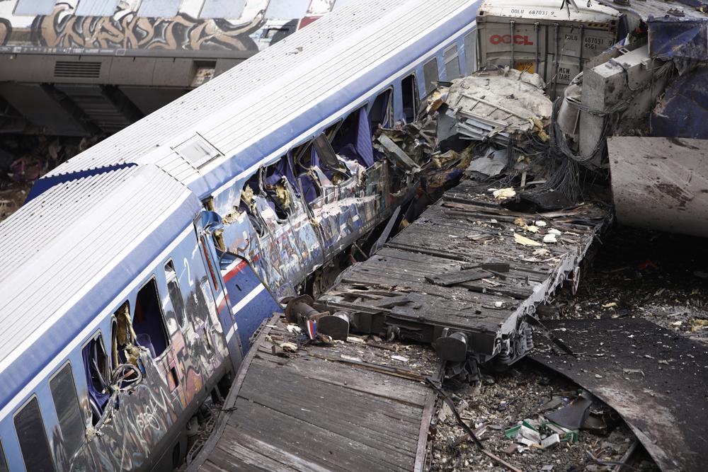 Debris of trains lie on the rail lines after a collision in Tempe, about 235 miles north of Athens, near Larissa city, Greece, Wednesday. A passenger train carrying hundreds of people, including many university students returning home from holiday, collided at high speed with an oncoming freight train before midnight on Tuesday.