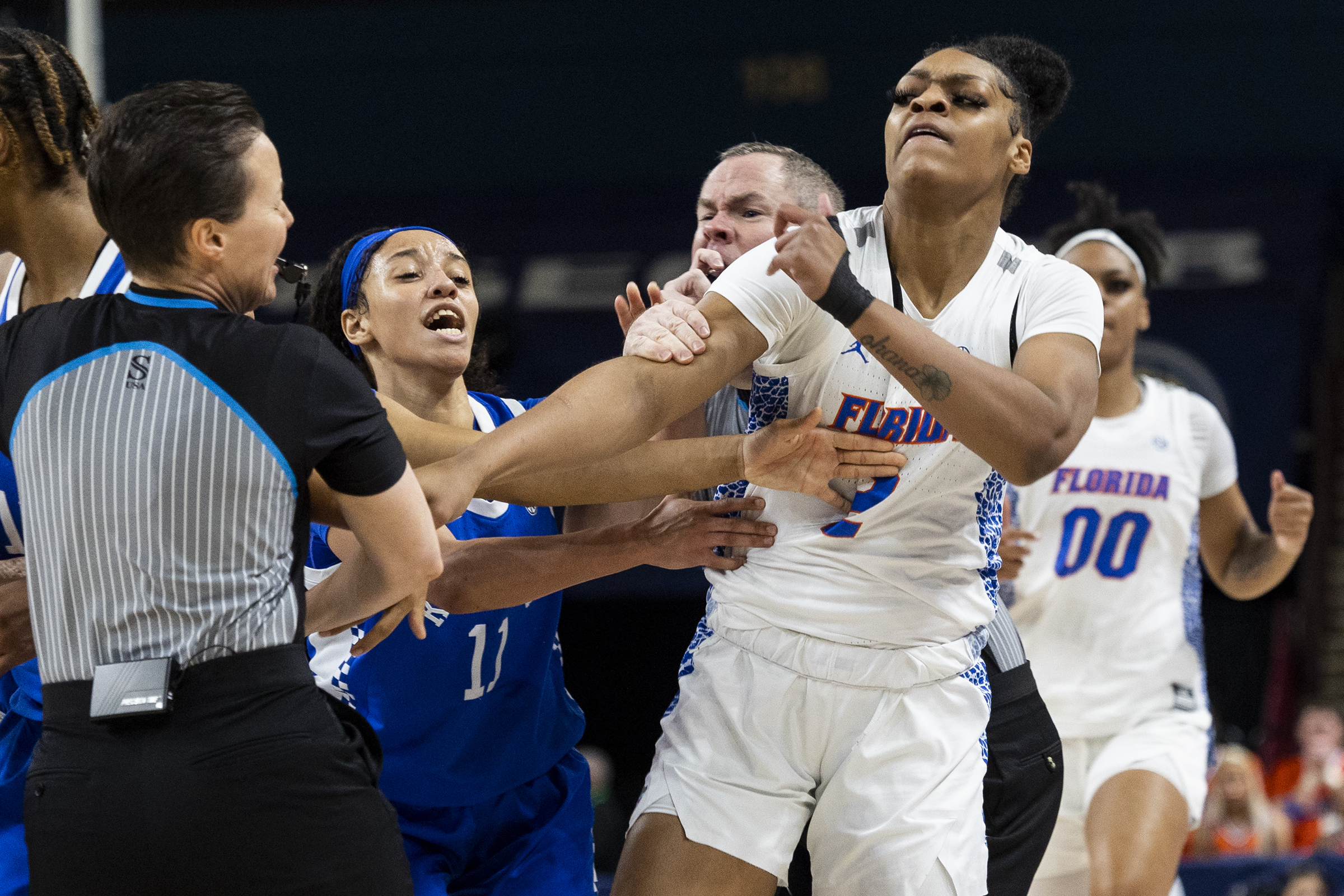 Florida's Tatyana Wyche (2) and Kentucky's Jada Walker (11) scuffle in the first half of an NCAA college basketball game during the Southeastern Conference women's tournament in Greenville, S.C., Wednesday, March 1, 2023. Several players from both teams were ejected from the game. 