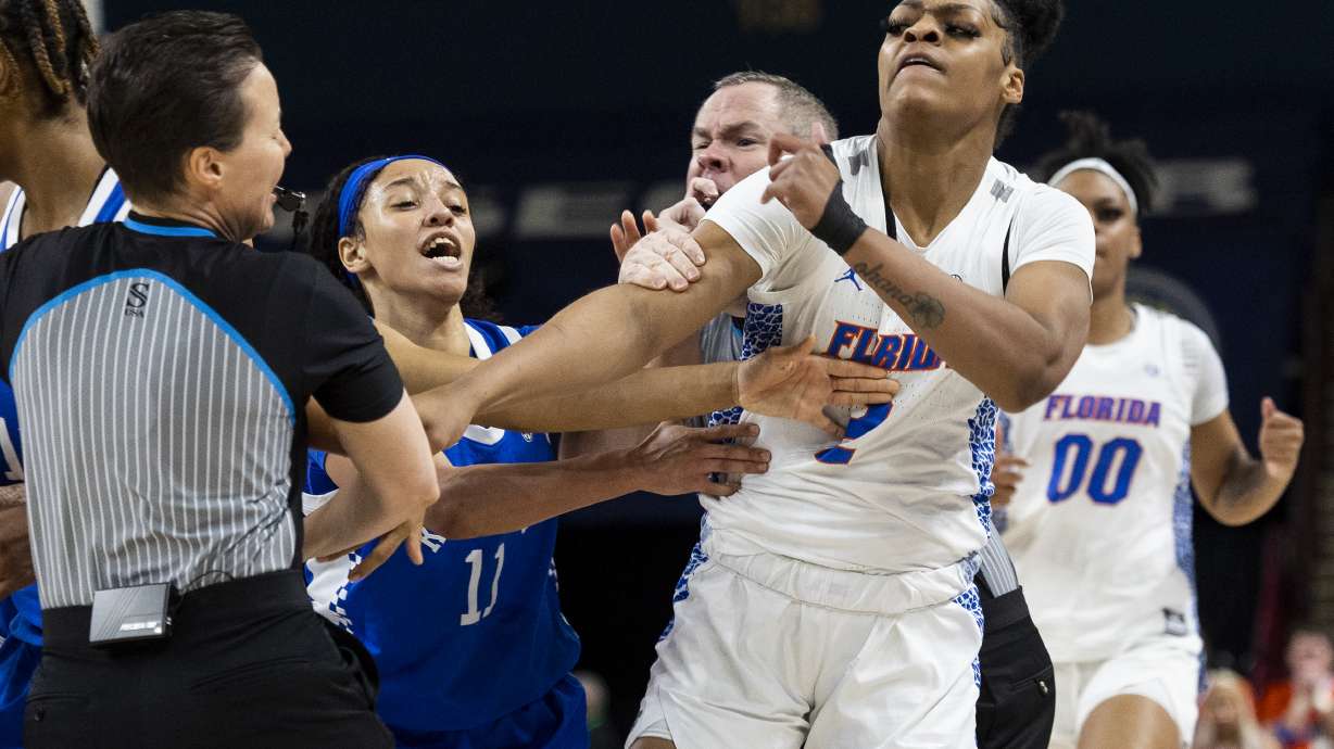 Florida's Tatyana Wyche (2) and Kentucky's Jada Walker (11) scuffle in the first half of an NCAA college basketball game during the Southeastern Conference women's tournament in Greenville, S.C., Wednesday, March 1, 2023. Several players from both teams were ejected from the game.