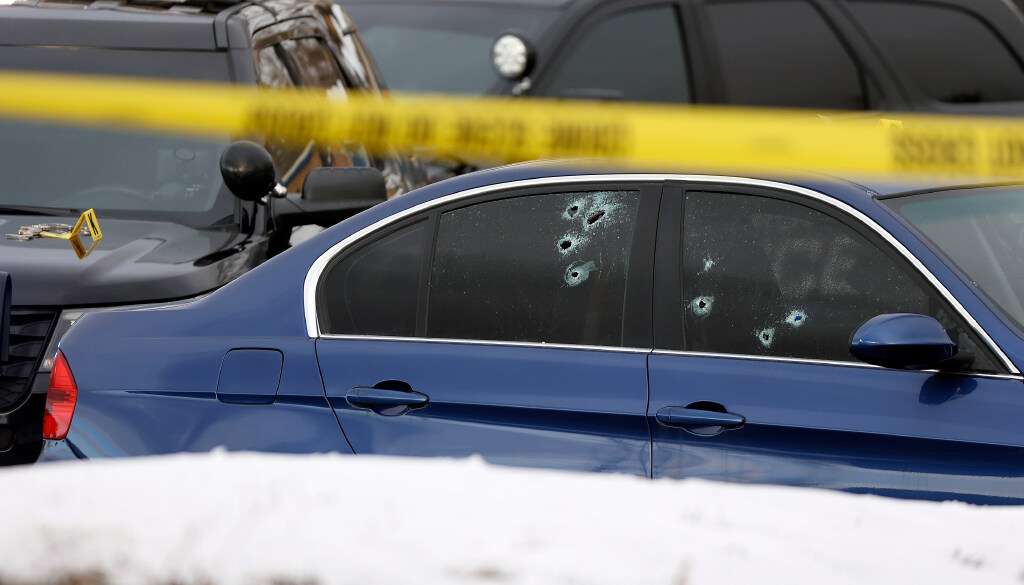 Bullet holes are pictured in car windows at the scene of a shooting in Farmington on Wednesday.