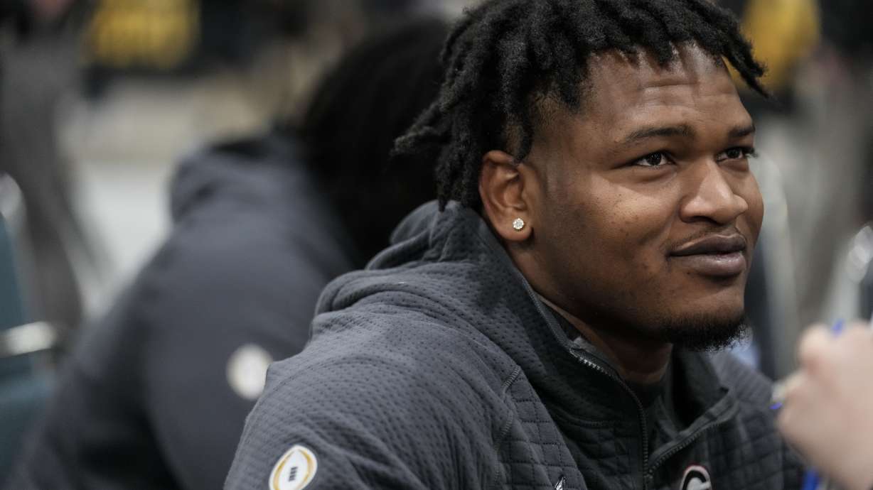 FILE - Georgia defensive lineman Jalen Carter speaks during media day ahead of the national championship NCAA College Football Playoff game between Georgia and TCU, Saturday, Jan. 7, 2023, in Los Angeles. Carter, projected as one of the top players in next month's NFL draft, has been charged with reckless driving and racing in conjunction with the crash that killed offensive lineman Devin Willock and a recruiting staff member. The Athens-Clarke County Police Department has issued an arrest warrant, obtained Wednesday, March 1, by The Associated Press, which alleges Carter was racing his 2021 Jeep Trackhawk against the 2021 Ford Expedition driven by the recruiting staffer, 24-year-old Chandler LeCroy, which led to the Jan. 15 wreck.