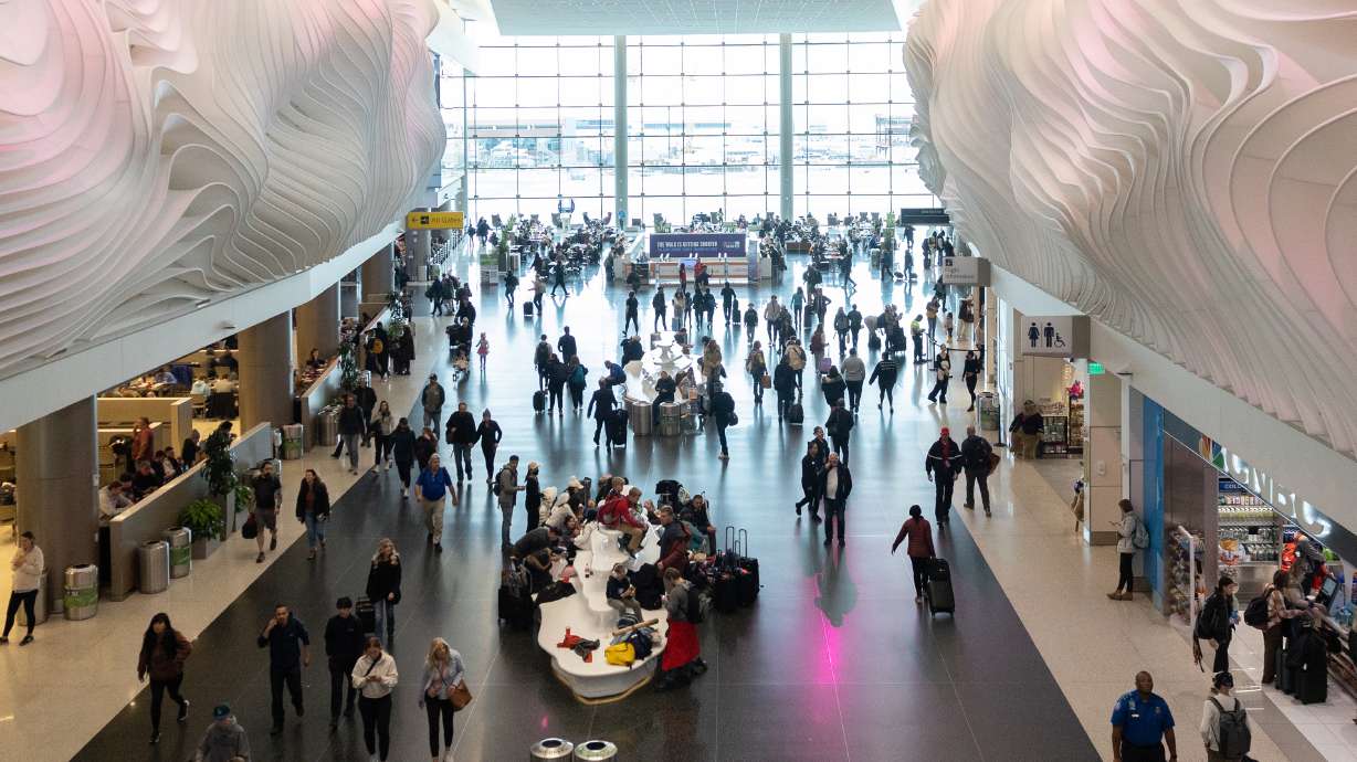 Travelers mill about Salt Lake City International Airport on Feb. 20. AAA said Thursday that this year's Christmas and New Year's rush is expected to be the second-largest since 2000, and air and cruise travel could exceed pre-pandemic levels.