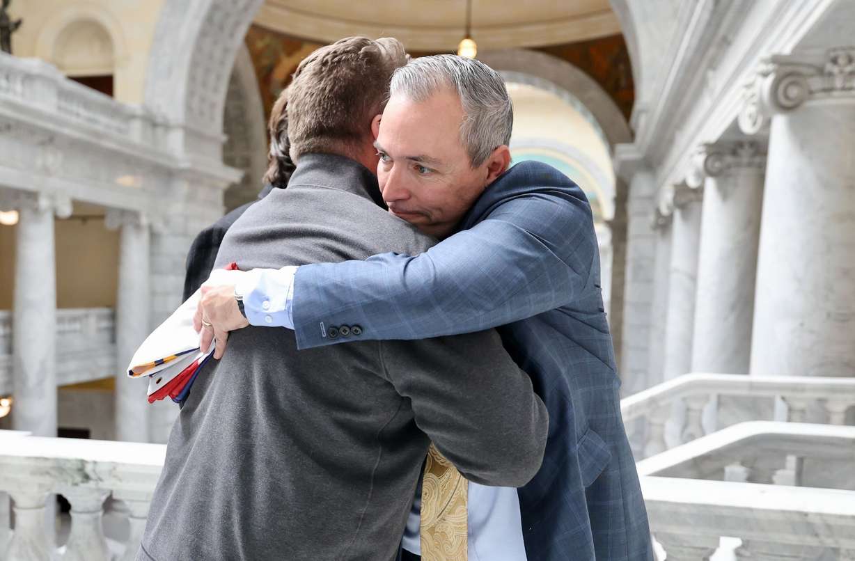 Sen. Dan McCay, right, embraces Mark Brooks at the Utah Capitol Thursday afternoon. Brooks was one of the designers behind the new Utah flag design that the Utah Legislature approved earlier in the day.