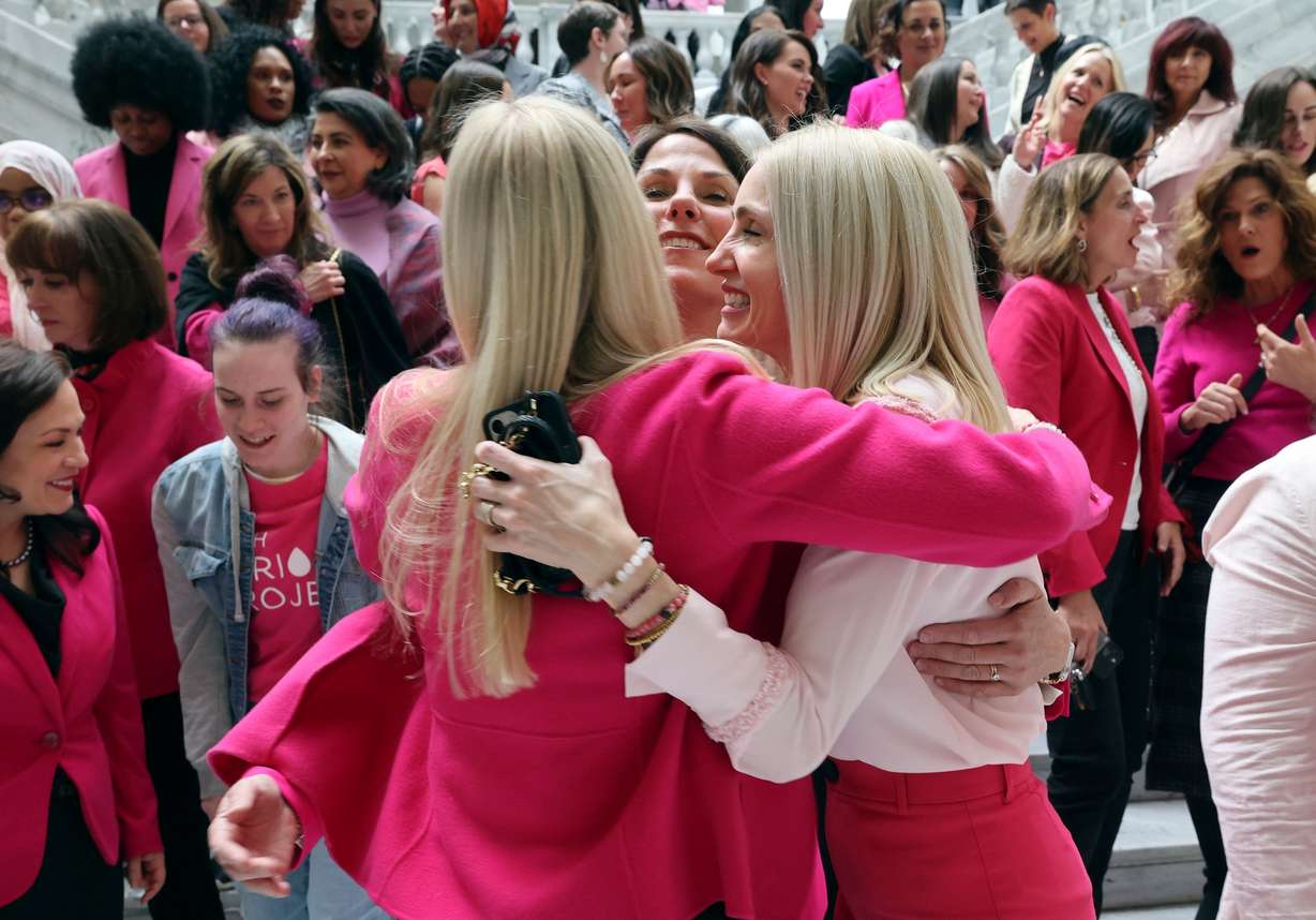 Jane Clayton, Mary Catherine Perry and Emily Bell McCormick, The Policy Project president and founder, embrace after a press conference to announce the state will provide free period products in all women’s and all-gender bathrooms in Utah’s executive state buildings in Salt Lake City on Thursday.