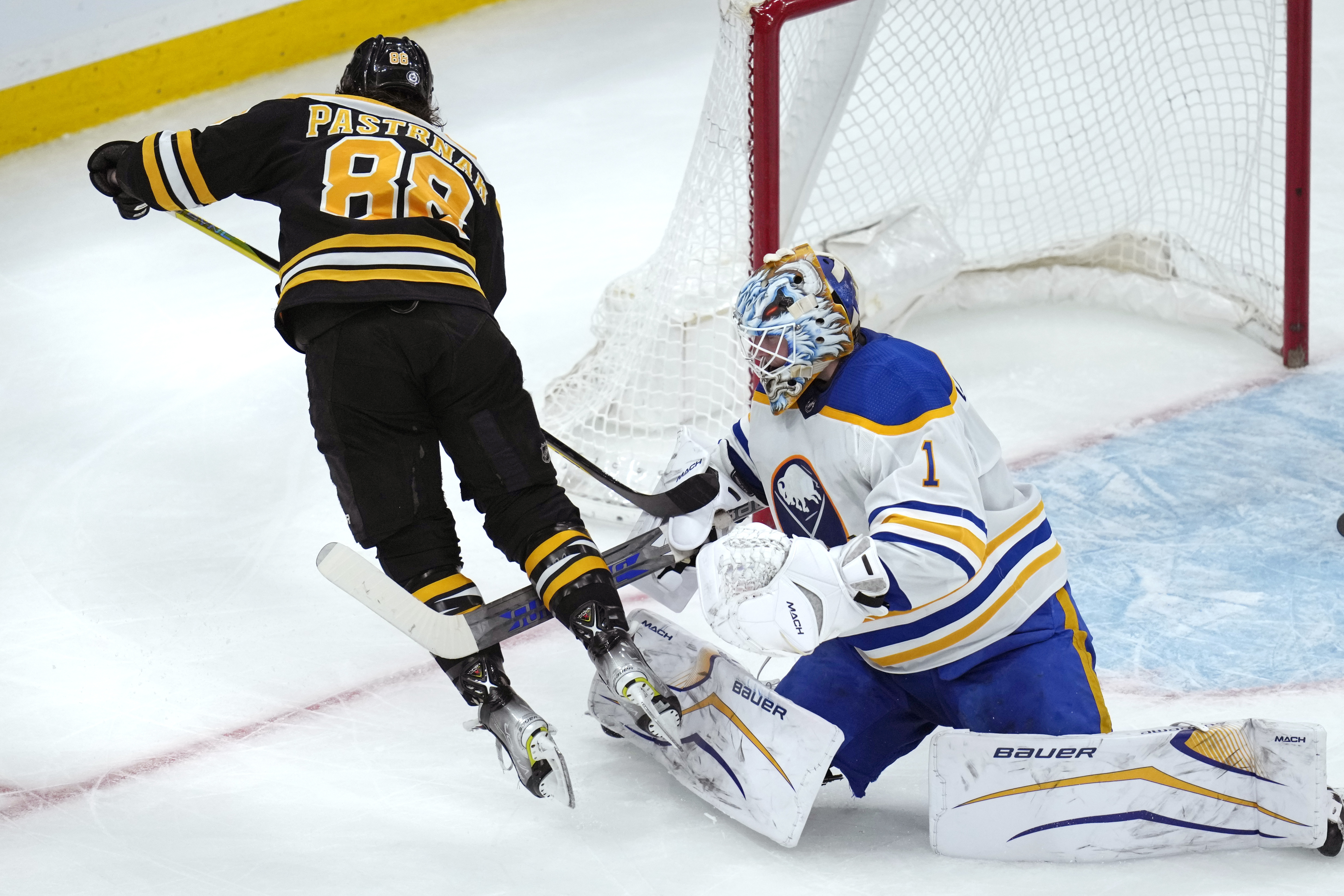 Buffalo Sabres goaltender Ukko-Pekka Luukkonen (1) trips Boston Bruins right wing David Pastrnak (88) during the second period of an NHL hockey game Thursday, March 2, 2023, in Boston. 