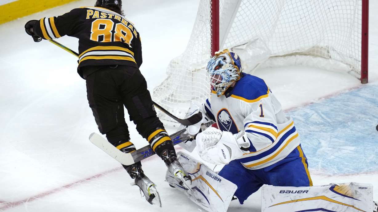 Buffalo Sabres goaltender Ukko-Pekka Luukkonen (1) trips Boston Bruins right wing David Pastrnak (88) during the second period of an NHL hockey game Thursday, March 2, 2023, in Boston.