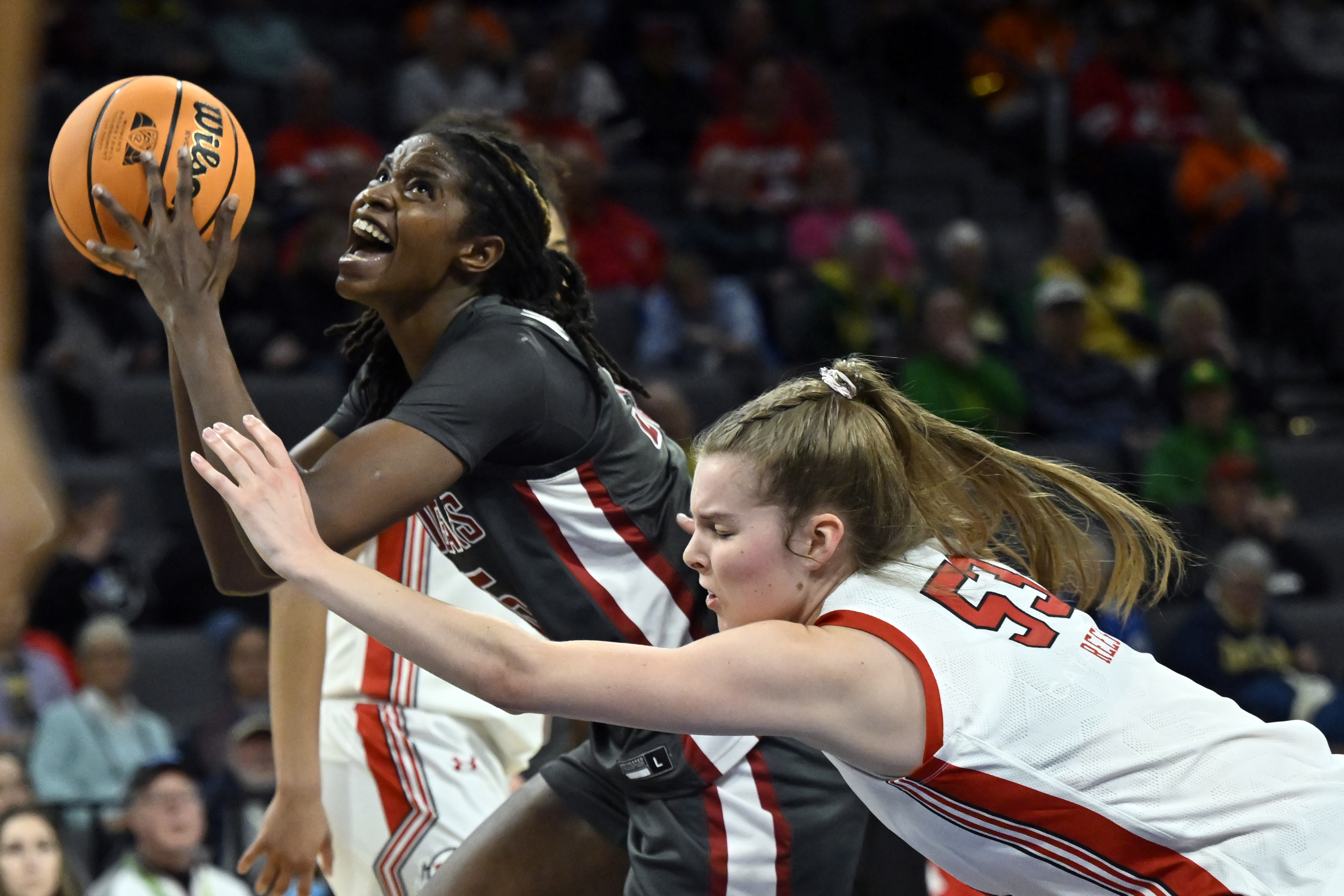 Washington State center Bella Murekatete, left, looks to shoot against Utah forward Kelsey Rees during the first half of an NCAA college basketball game in the quarterfinals of the Pac-12 women's tournament Thursday, March 2, 2023, in Las Vegas.