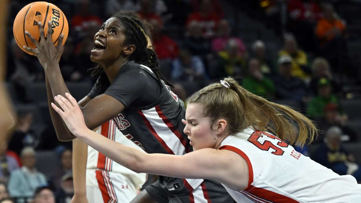 Washington State center Bella Murekatete, left, looks to shoot against Utah forward Kelsey Rees during the first half of an NCAA college basketball game in the quarterfinals of the Pac-12 women's tournament Thursday, March 2, 2023, in Las Vegas.